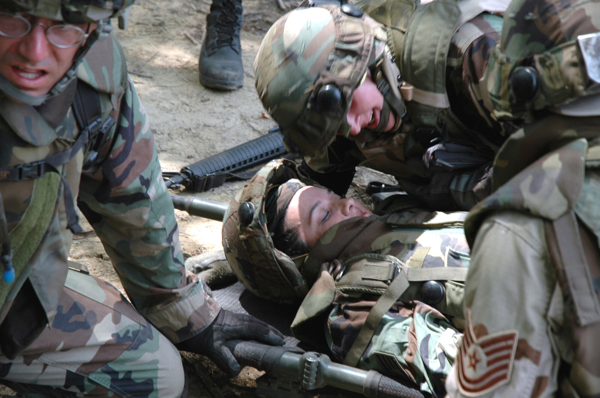 Students in the Advanced Contingency Skills Training Course 08-5 practice combat first aid during training in the course July 17, 2008, on a Fort Dix, N.J., range.  ACST, taught by the U.S. Air Force Expeditionary Center's 421st Combat Training Squadron, prepares Airmen for upcoming deployments.  (U.S. Air Force Photo/Staff Sgt. Paul R. Evans)