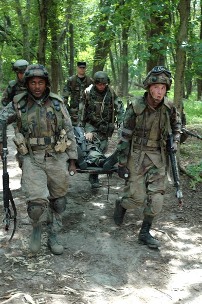 Students in the Advanced Contingency Skills Training Course 08-5 practice combat first aid during training in the course July 17, 2008, on a Fort Dix, N.J., range.  ACST, taught by the U.S. Air Force Expeditionary Center's 421st Combat Training Squadron, prepares Airmen for upcoming deployments.  (U.S. Air Force Photo/Staff Sgt. Paul R. Evans)