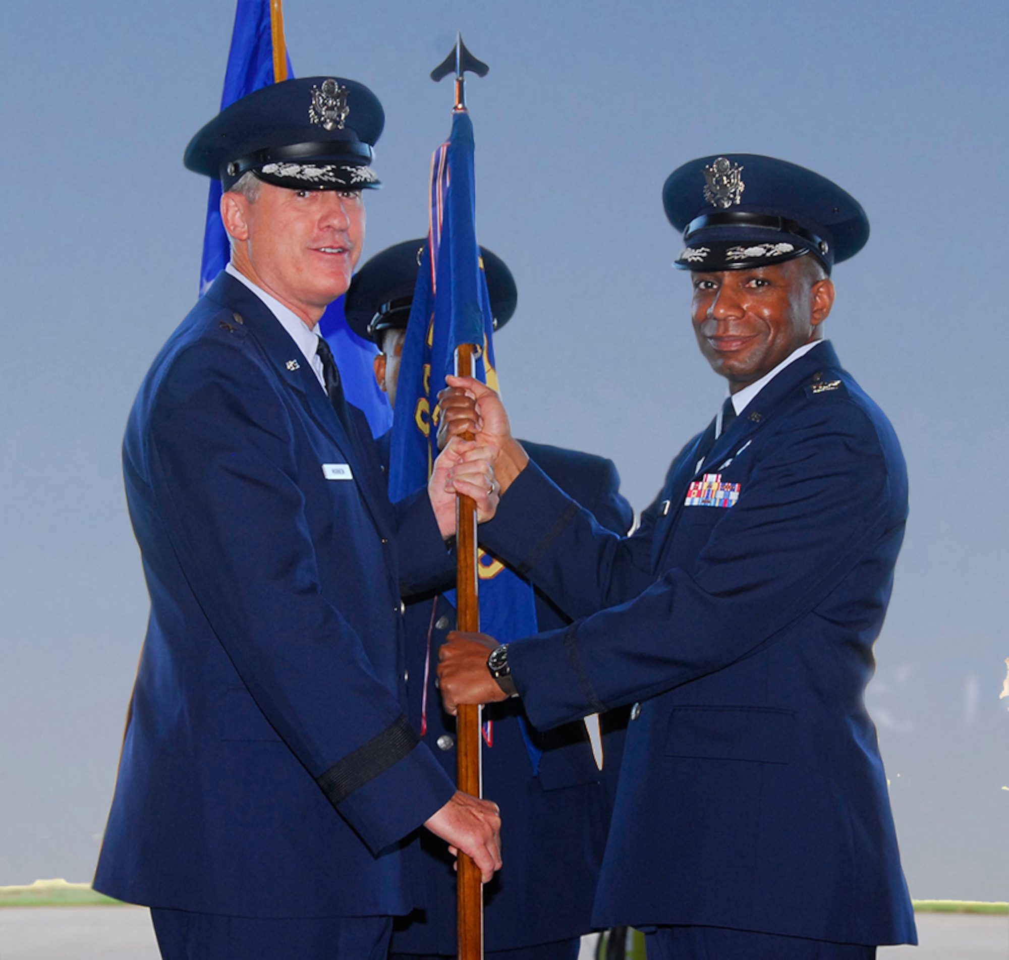 Brig. Gen. O.G. Mannon gives the guidon to Col. Tony Pounds, the incoming commander of the 782nd Training Group, at a change-of-command ceremony July 22 in Hangar 1010.
