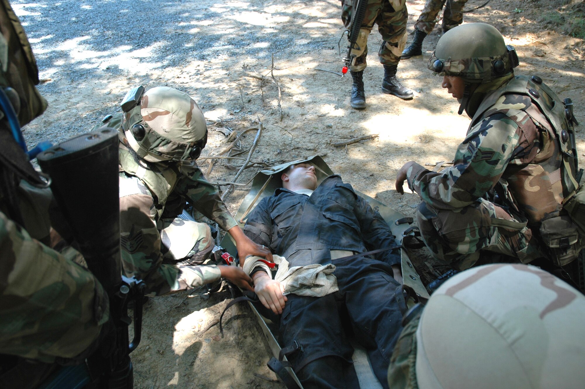 Students in the Advanced Contingency Skills Training Course 08-5 practice combat first aid during training in the course July 16, 2008, on a Fort Dix, N.J., range.  The course, taught by the U.S. Air Force Expeditionary Center's 421st Combat Training Squadron, prepares Airmen for upcoming deployments.  (U.S. Air Force Photo/Staff Sgt. Paul R. Evans)
