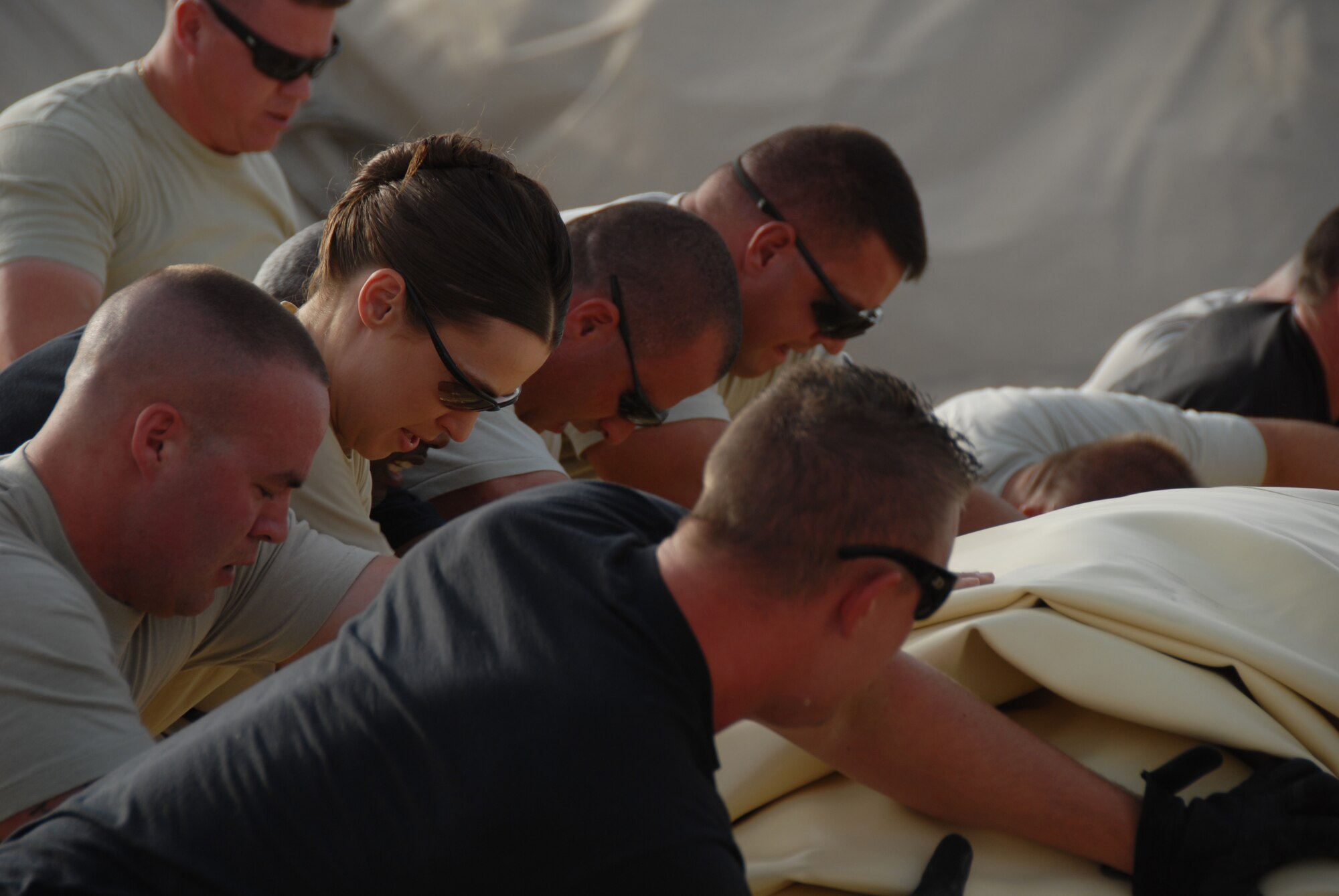 Lt. Col. Tanya Kubinec, Commander of the 380 Expeditionary Logistics Readiness Squadron, works with her troops to roll out a new fuel bladder. The fuel bladder weighs approximately 2.5 tons empty and it can hold 200,000 gallons of fuel. ELRS changed out the bladder due to normal wear and tear and climate conditions.(U.S. Air Force photo/Tech. Sgt. Christopher A Campbell)
