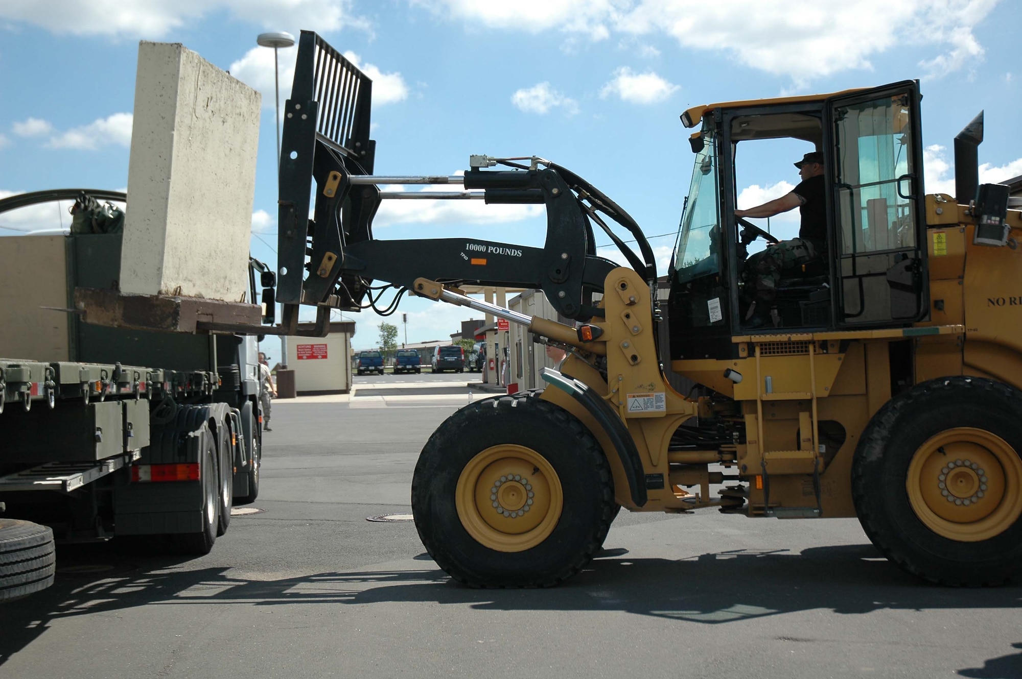 Senior Airman Joseph Sowden, 944th Logistics Readiness Squadron, puts a barrier onto a truck in preparation for the Open House at Spangdahlem Air Base, Germany. Airman Sowden is a reservist deployed to Germany for annual training and to augment the 52nd Fighter Wing. (U.S. Air Force photo/Tech. Sgt. Susan Stout)