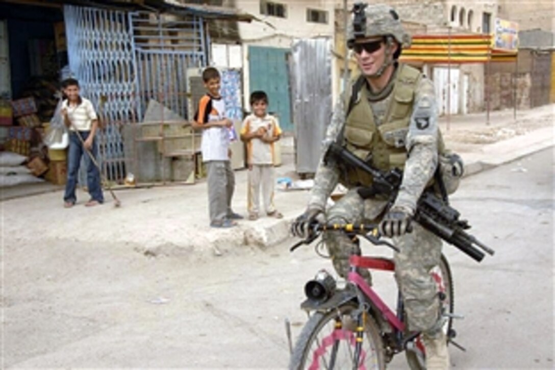 U.S. Army Sgt. Mark Speakman takes a bike for a ride during a patrol in the Shula district, Baghdad, Iraq, July 20, 2008. Speakman is assigned to the 101st Airborne Division's 2nd Brigade Combat Team, 75th Cavalry Regiment. 
