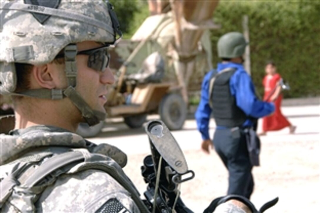 U.S. Army Cpt. Michael Kolton conducts a combined dismounted patrol with Iraqi police officers in the Ghazaliya district, Baghdad, Iraq, July, 18, 2008. Kolton is the platoon leader, 4th Platoon, Bravo Troop, 1st Squadron, 75th Cavalry, 2nd Brigade Combat Team, 101st Airborne Division. 
