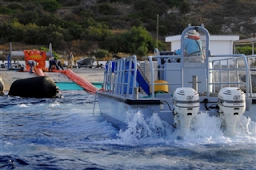 An oil spill response team at U.S. Naval Support Activity Souda Bay deploys a "Harbour Buster" high-speed oil containment system during a drill to test procedures to contain and recover oil during a spill, Crete, Greece, July 23, 2008.