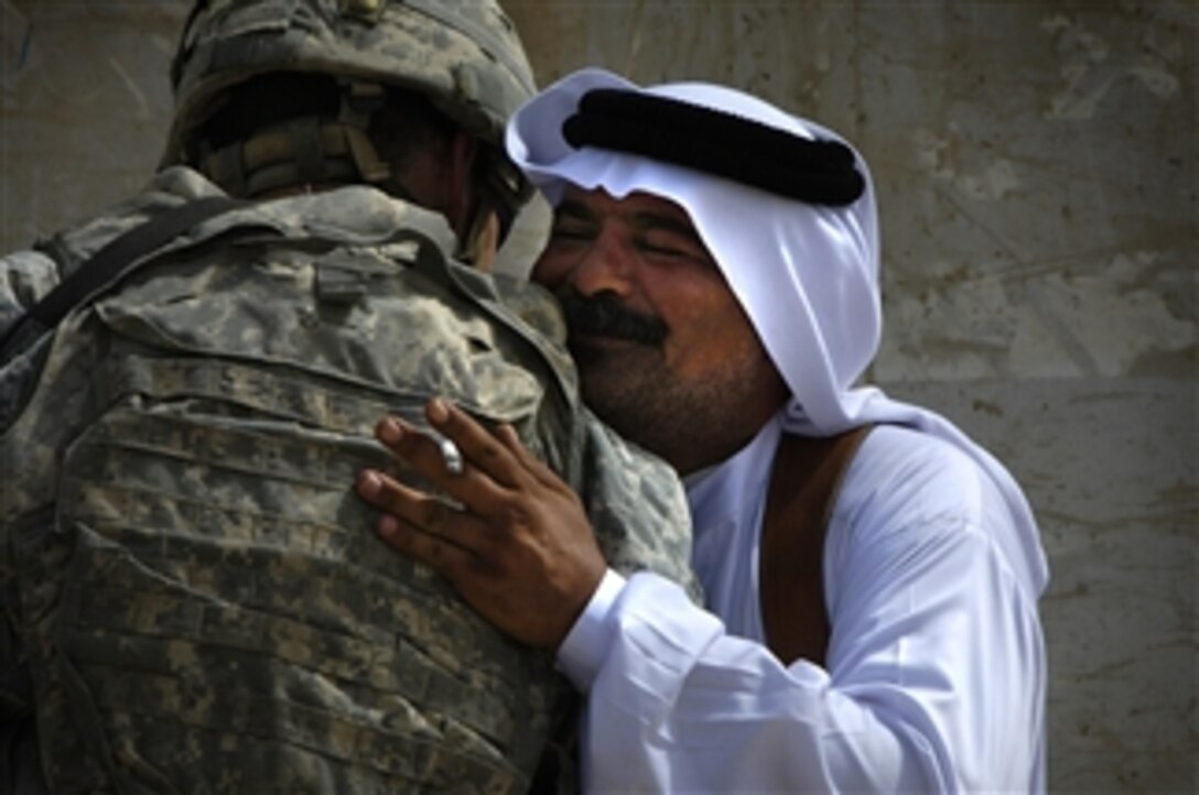 A local sheik greets U.S. Army Capt. Brian Sweigart of 1st Battalion, 27th Infantry Regiment, 25th Infantry Division at a newly constructed school in the Al Awad region of Iraq on July 17, 2008.  