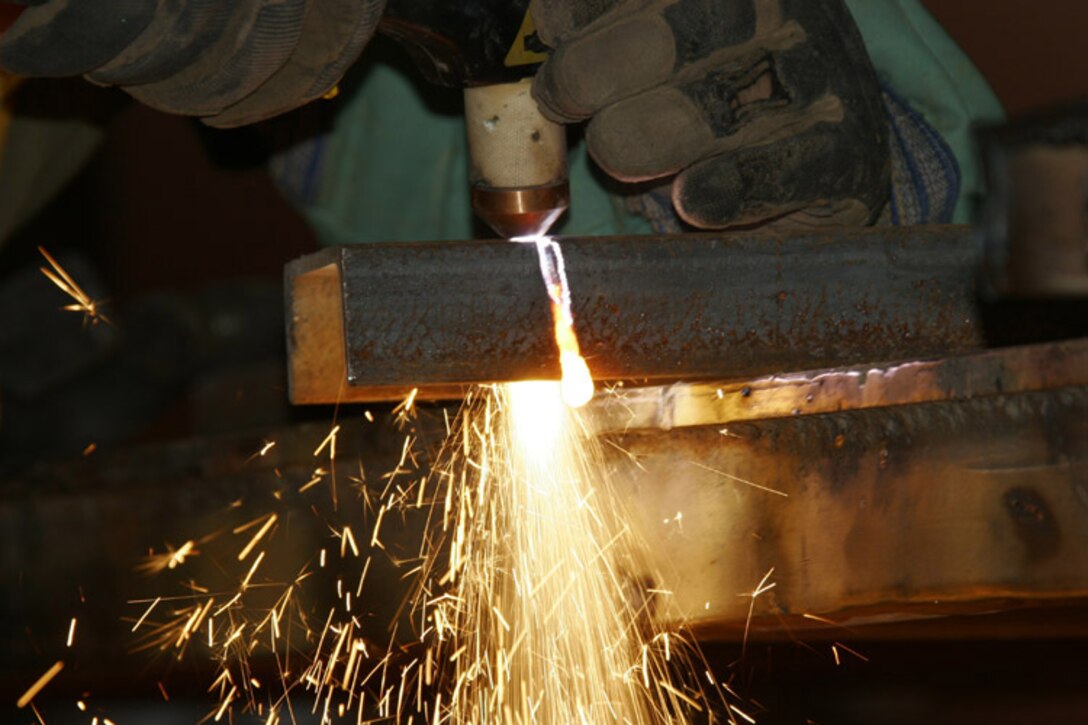 Sergeant Jason Walsh and Cpl. John James, metal workers with Marine Wing Support Squadron 172, Marine Wing Support Group 37, 3rd Marine Aircraft Wing (Forward), created a bracket designed to mount security equipment on towers. The Marines look forward to patenting their idea.