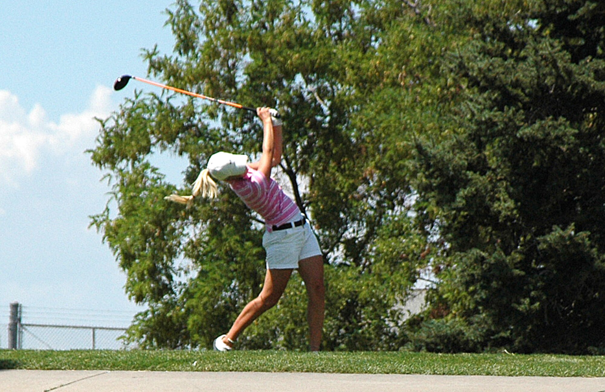 Camille Gardner, 20, of Fruit Heights, tees off on Hole 14 of the 102nd Utah State Women's Amateur golf tournament at Hubbard Golf Course on Hill Air Force Base.  The tournament determines the best amateur female golfer in thee state of Utah by only allowing Utah residents with a handicap of 36 or lower to compete for the title.  The tournament was held over a three-day period, July 21-23.  Title play was still ongoing at press time.  Next week: the winners and a wrap-up of the last day's competition. 