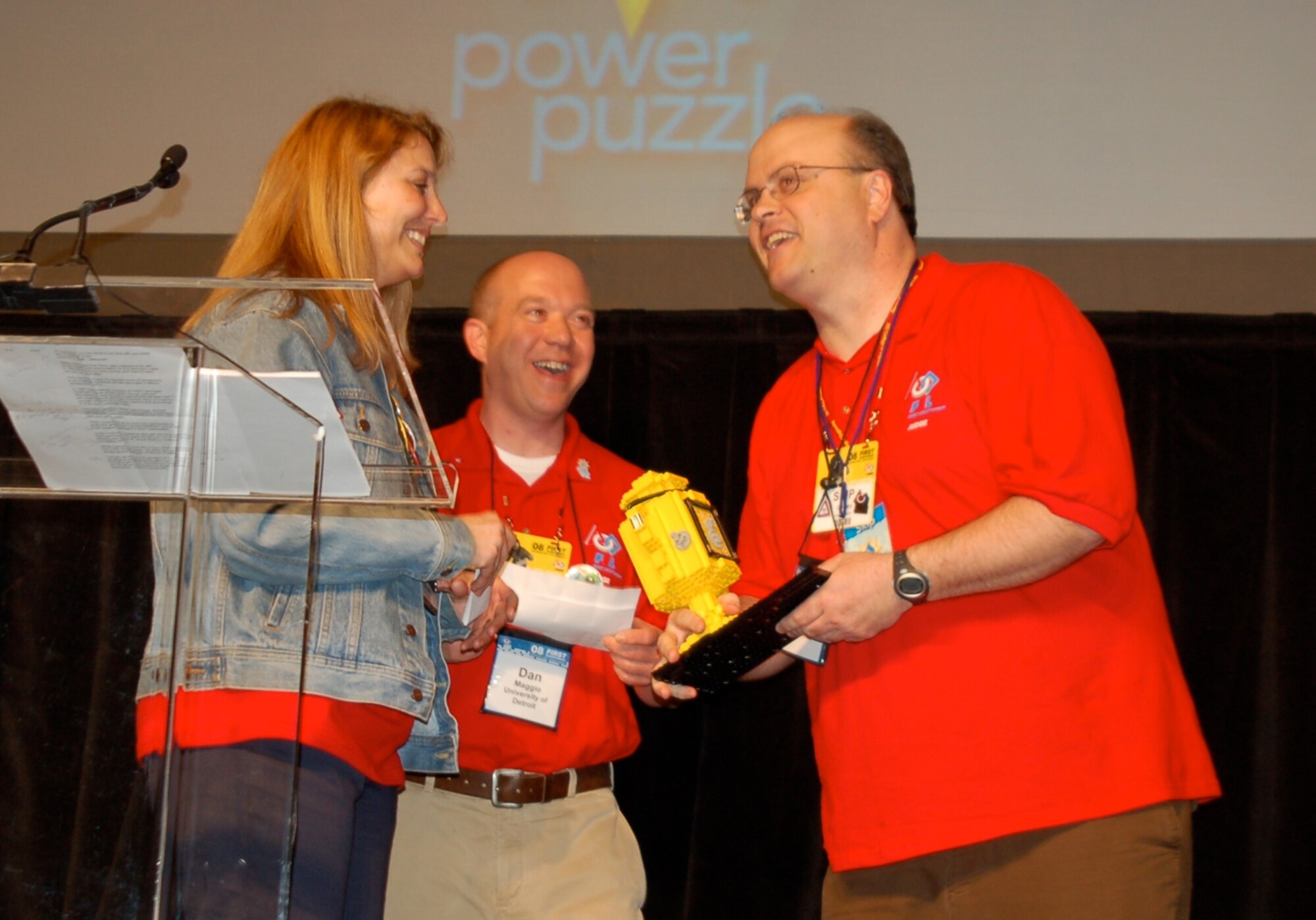 Skip Gridley (right), engineer with the AFRL Air Vehicles Directorate at Wright-Patterson Air Force Base, Ohio, accepts the FIRST LEGO League World Festival Volunteer Award from FLL Head Teamwork Judges Kathy Levine and Dan Maggio. (Courtesy of Nick Swayne/James Madison University)