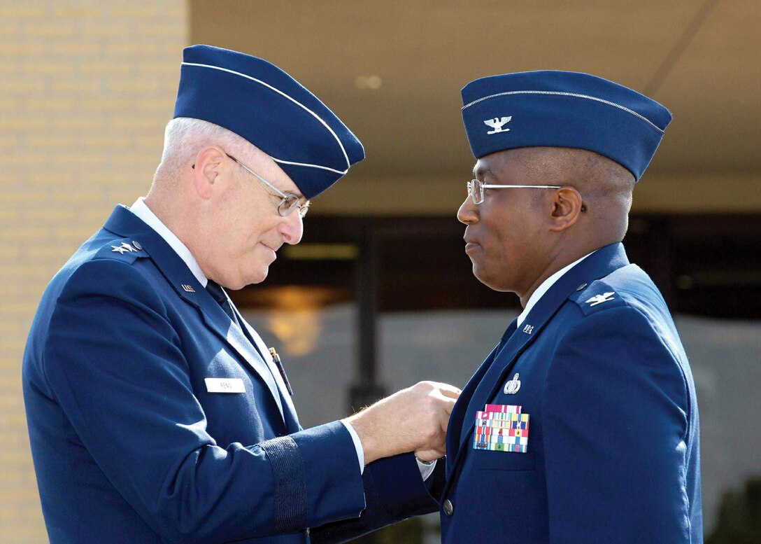 Maj. Gen. Loren Reno affixes a commander?s pin to Col. Allen Jamerson?s uniform moments after the colonel became the new commander of the 72nd Air Base Wing during a July 18 ceremony at Tinker Air Force Base, Okla. The wing has African Americans currently serving in its top three leadership positions.  (U.S. Air Force photo/Margo Wright) 