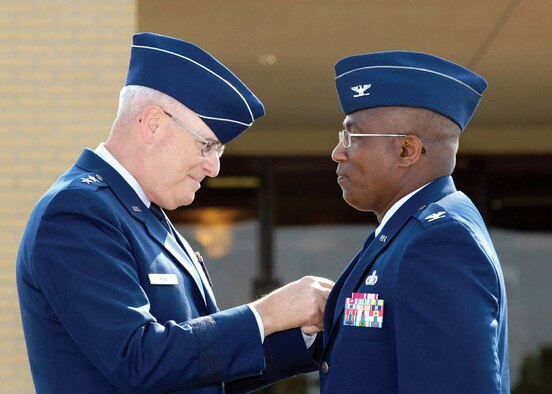 Maj. Gen. Loren Reno affixes a commander's pin to Col. Allen Jamerson's uniform moments after the colonel assumed command of the 72nd Air Base Wing during a July 18 ceremony at Tinker Air Force Base, Okla. (Air Force photo by Margo Wright)
