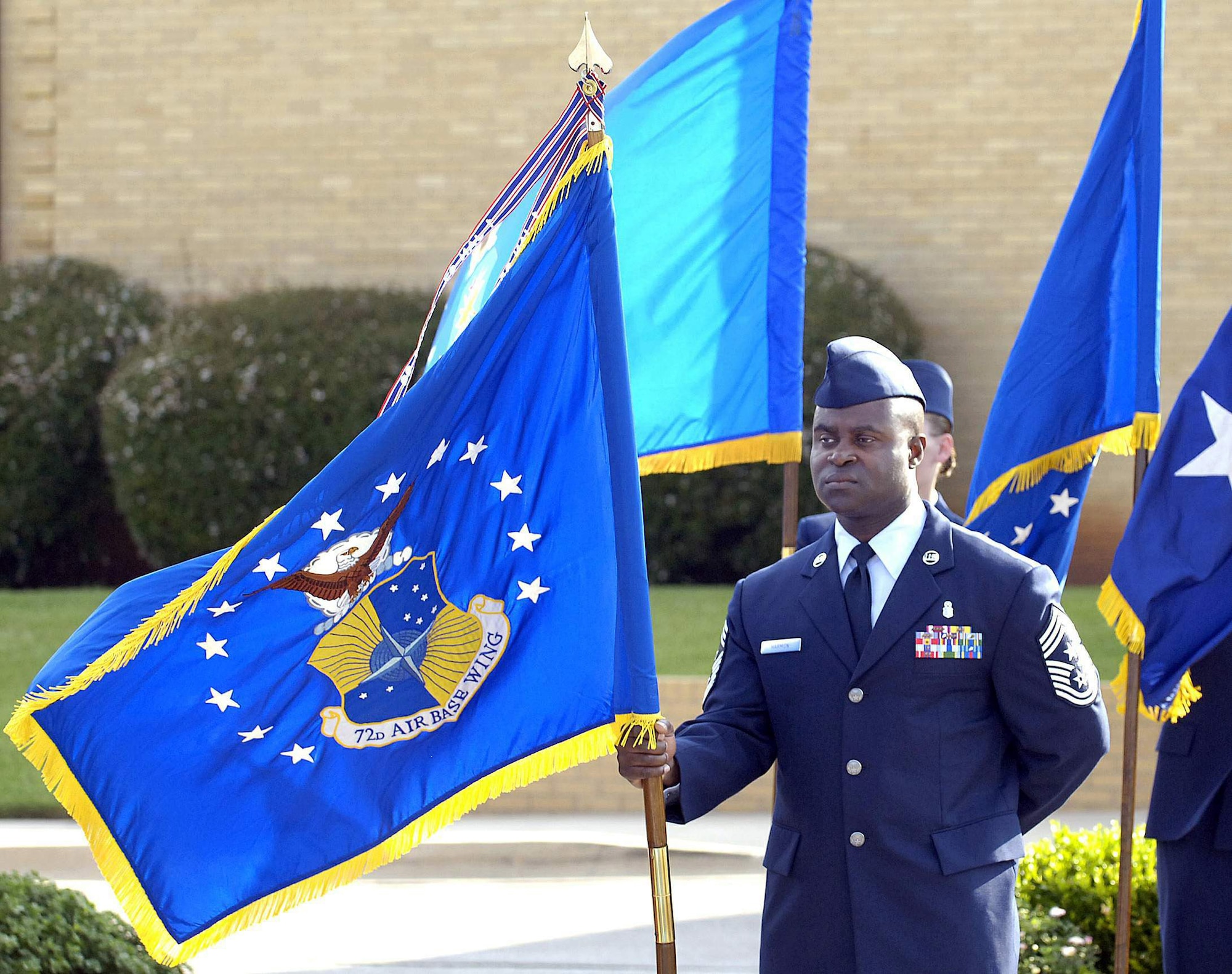 Chief Master Sgt. Eric Harmon, the 72nd Air Base Wing command chief, holds the wing guideon during Col. Allen Jamerson's assumption of command ceremony July 18 of the wing at Tinker Air Force Base, Okla. The wing has African Americans currently serving in its top three leadership positions. (U.S. Air Force photo/Margo Wright) 