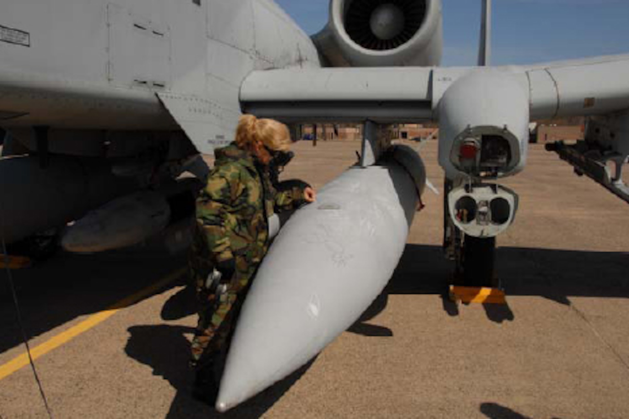 Tech. Sgt. Regina L. Bergonzi of the 103rd Maintenance Squadron writes a farewell message on one of the last two A-10s before it left the ramp here April 8, 2008 for the last time. (U.S. Air Force Photo by Maj. George Worrall III)