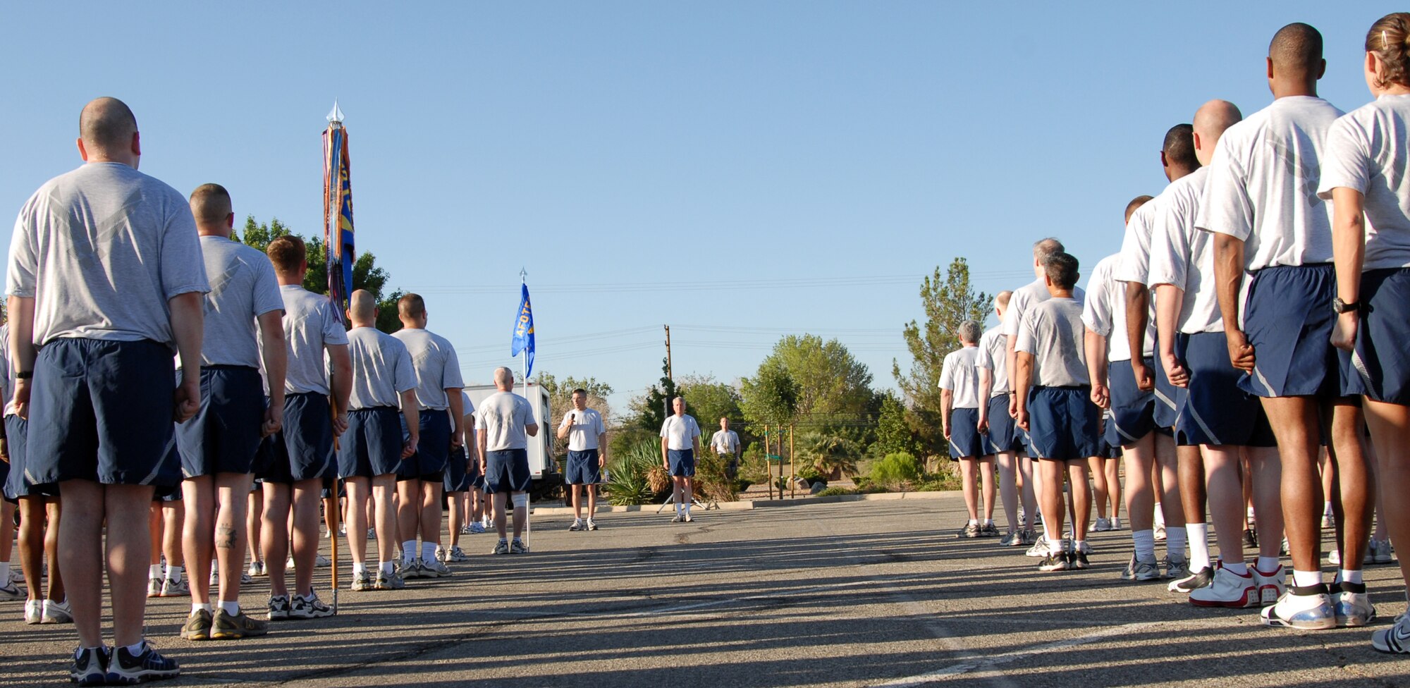Edwards Airmen stand at attention to recite the Airman's Creed after the installation fitness run July 25. More than 800 Airmen and Marines participated in the 1.5-mile run to promote fitness and esprit de corps. (Air Force photo by Senior Airman Stacy Sanchez)