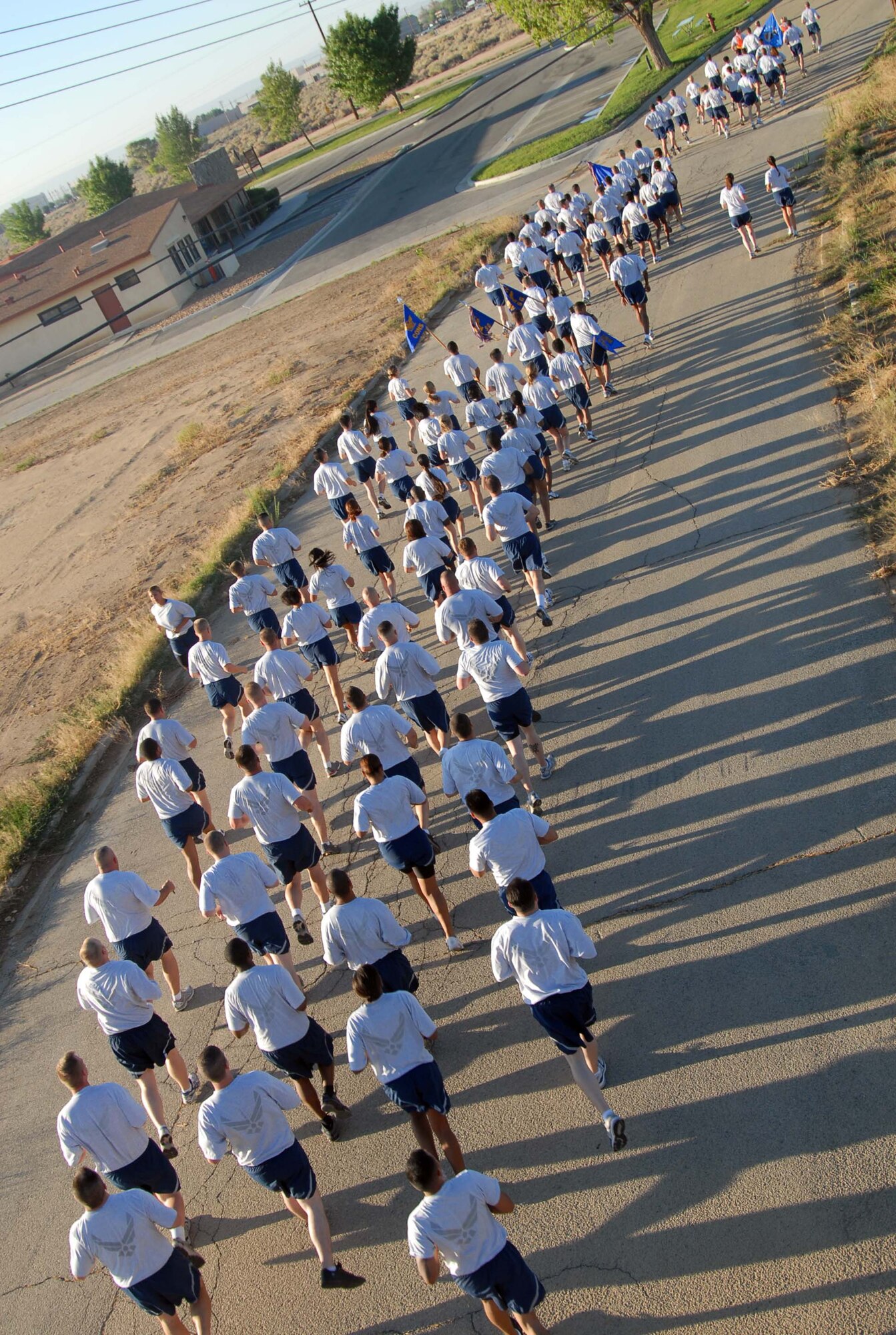 Edwards Airmen run during an installation fitness run July 25. More than 700 Airmen and Marines participated in the 1.5-mile run to promote fitness and esprit de corps. (Air Force photo by Senior Airman Julius Delos Reyes)
