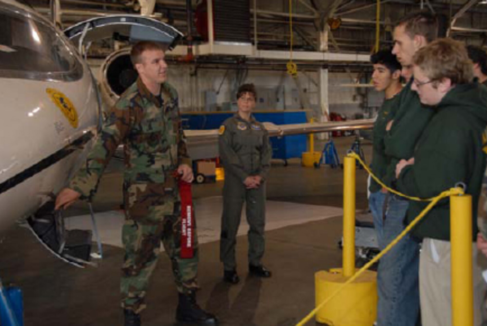 Staff Sgt. Jon Favreau, C-21 crew chief, and Capt. Aline Trychon, flight nurse, 103rd Airlift Wing, Bradley Air National Guard Base, East Granby, Conn., explain the Medical Evacuation mission to students from Emmett O’Brien Vocational Technical School during Career Day at Bradley Air National Guard Base on May 8, 2008. (U.S. Air Force photo by Master Sgt. Jeanne E. Daigneau)