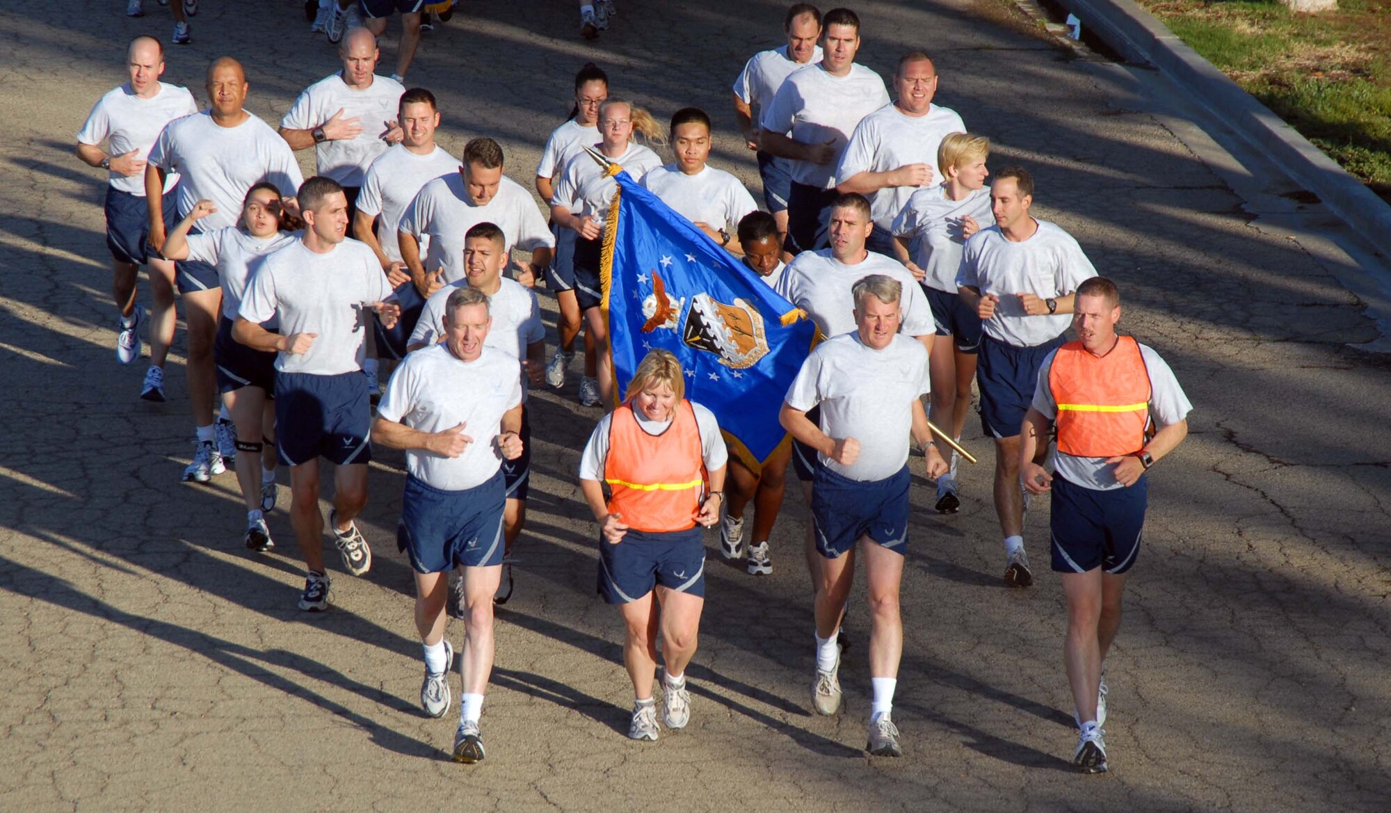 Maj. Gen. David Eichhorn (foreground, second from right), Air Force Flight Test Center commander, leads more than 800 Edwards Airmen and Marines during a 1.5-mile installation fitness run July 25. (Air Force photo by Senior Airman Julius Delos Reyes)