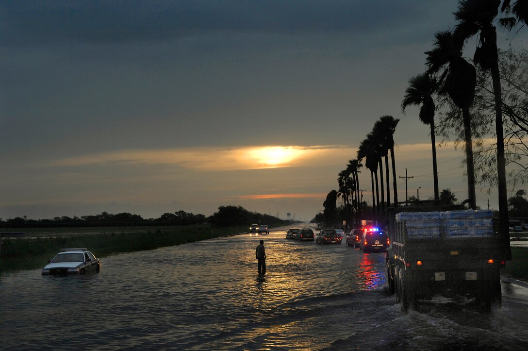 A Texas Task Force 1 convoy rolls through the aftermath of Hurricane Dolly July 24 towards South Padre Island, Texas. The convoy was composed of Army and Air Force National Guard members along with civilian emergency response team. (U.S. Air Force photo/Staff Sgt. Bennie J. Davis III)