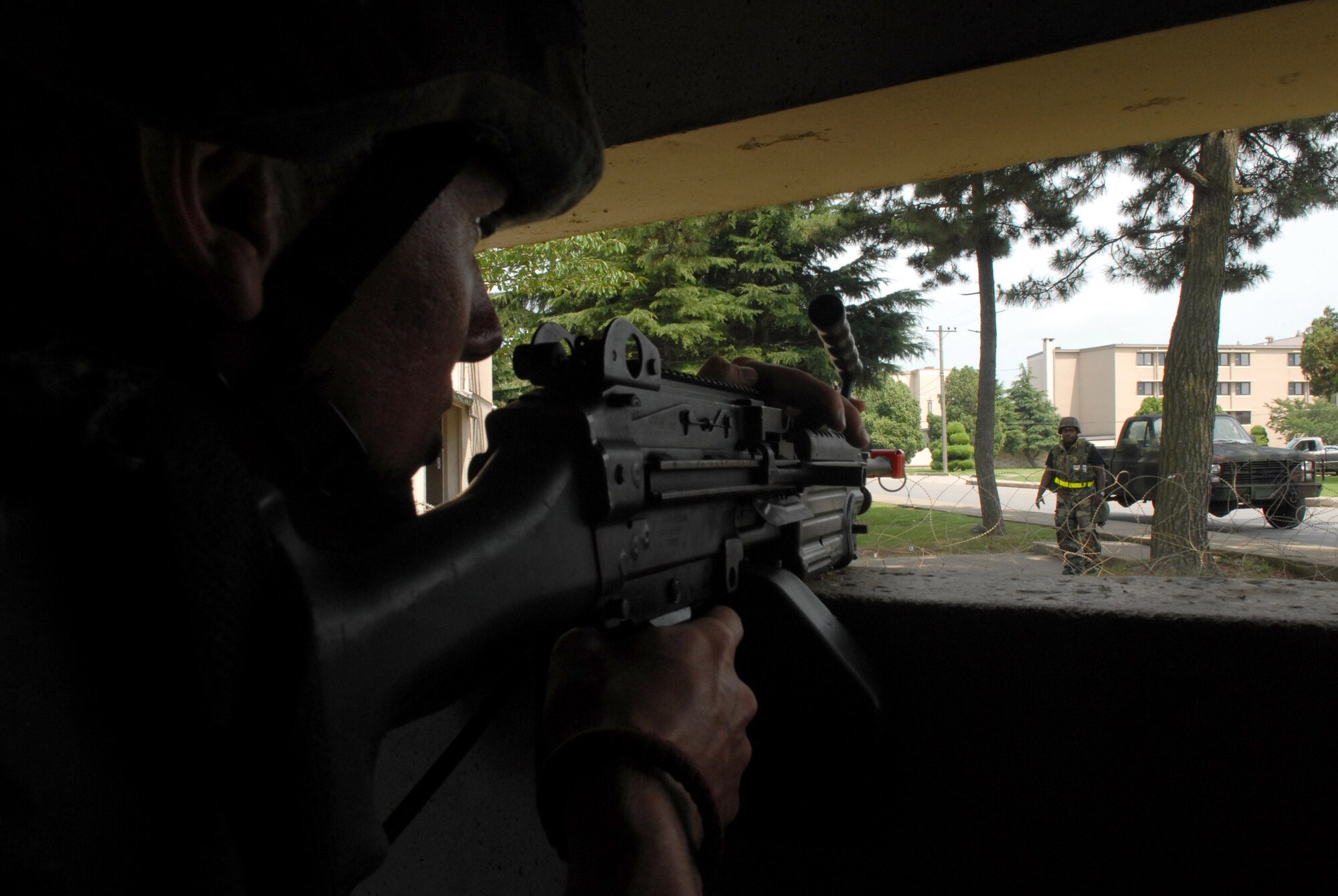Senior Airman Christopher Kaffer challenges Staff Sgt. Derrick Spencer at an entry control point July 22 at Kunsan Air Base, South Korea. The Airmen are participating in a peninsula wide operational readiness exercise, BEVERLY BULLDOG 08-03, held to train U.S. forces throughout South Korea. Airman Kaffer is with the 8th Security Forces Squadron. (U.S. Air Force photo by/Senior Airman Angela Ruiz) 
