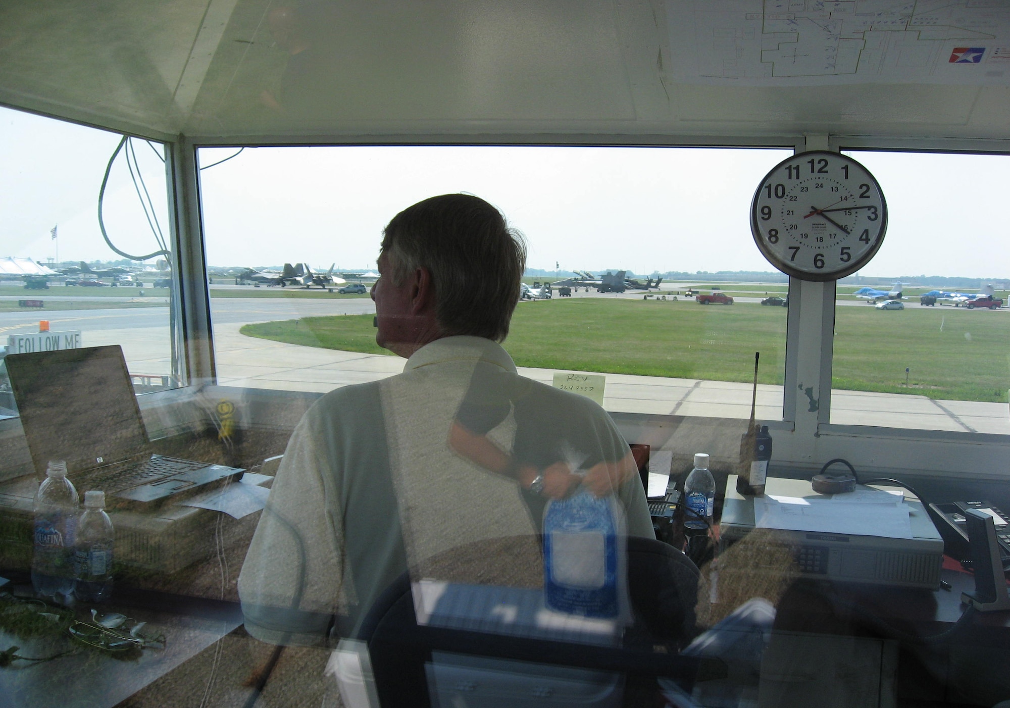 From a remote tower cab, Dave Egner, 88th Operations Support Squadron director of special operations, monitors military aircraft arrivals for the Dayton Air Show at Dayton International Airport, Ohio July 18.  Nearly 400 Wright-Patterson Air Force Base Airmen and civilian employees provided aircraft operations, marshalling, fuels, security, medical, services and public affairs support for the event. (U.S. Air Force photo/Derek Kaufman)