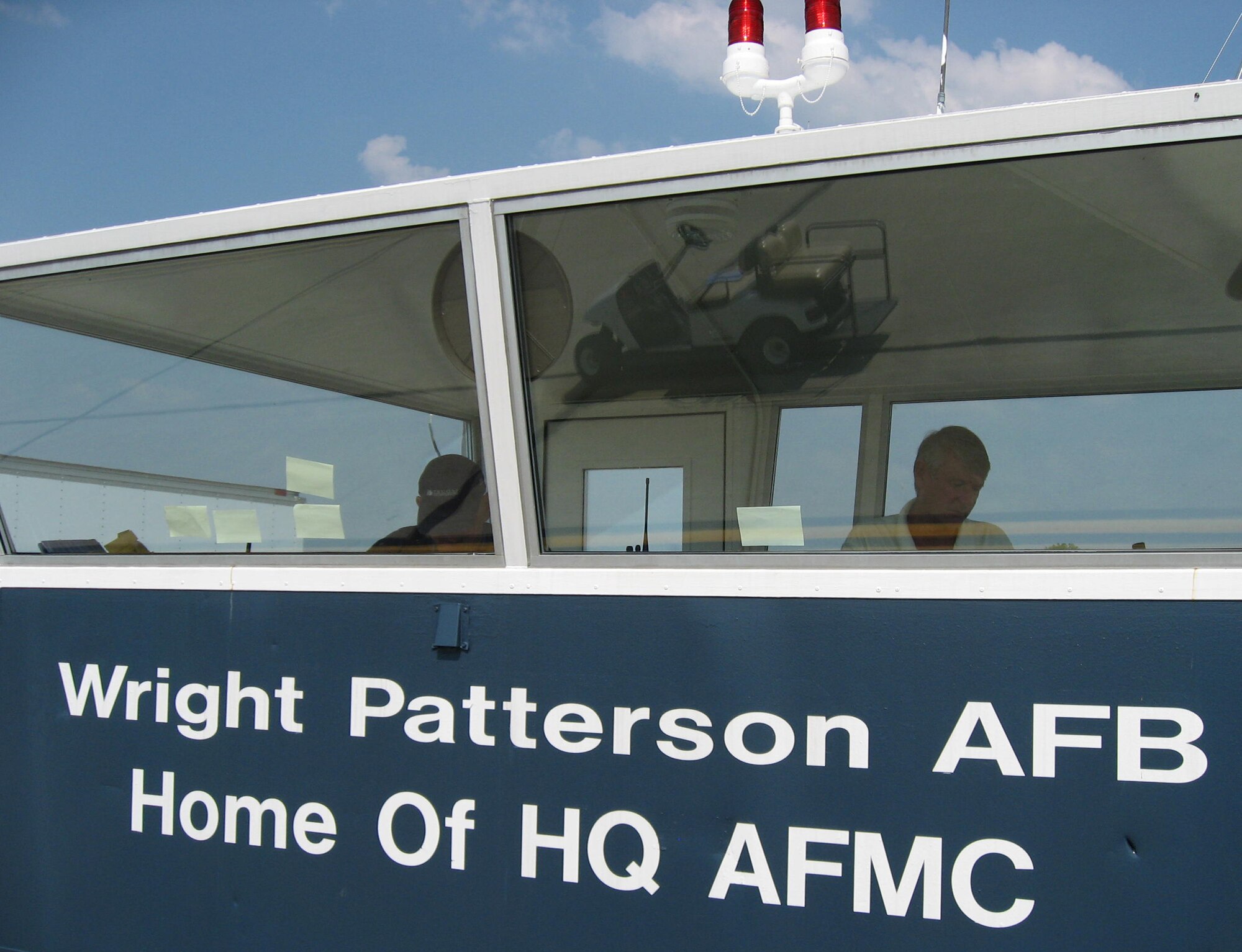 From a remote tower cab, Tom Ohrman of the 88th Air Base Wing Public Affairs Multimedia Center and Dave Egner, 88th Operations Support Squadron director of special operations, monitor military aircraft arrivals for the Dayton Air Show at Dayton International Airport, Ohio July 18.  Nearly 400 Wright-Patterson Air Force Base Airmen and civilian employees provided aircraft operations, marshalling, fuels, security, medical, services and public affairs support for the event. (U.S. Air Force photo/Derek Kaufman)