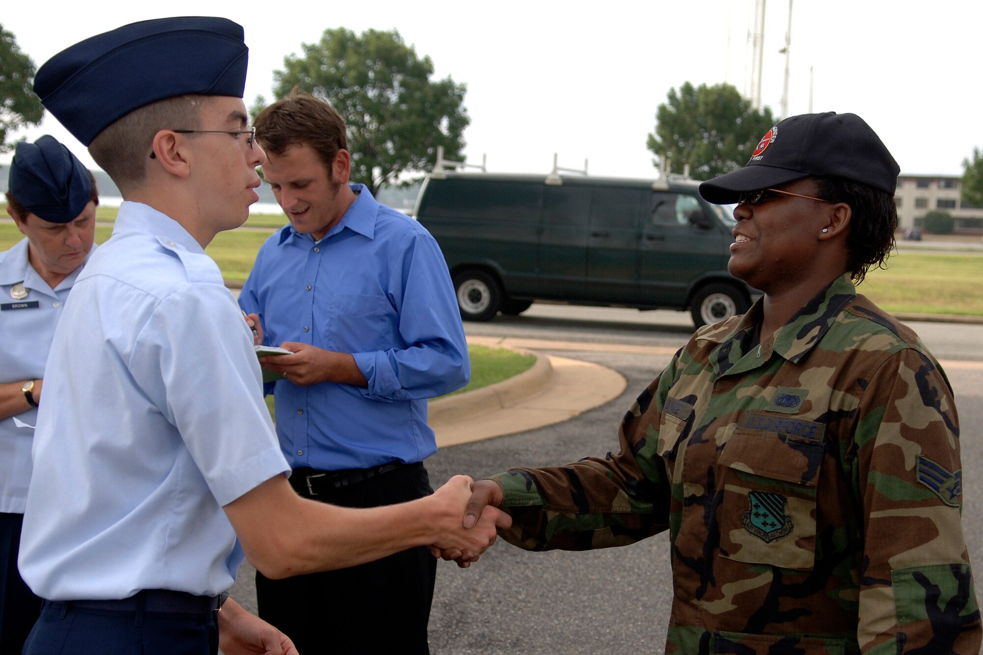 LANGLEY AIR FORCE BASE, Va. --  Senior Airman Yvonette France, 1st Civil Engineering Squadron, greets Cadet Chris Burtner, an Air Force Junior Reserve Officer Training Corps student from Menchville High School who shadowed her for the day here on July 24.  The cadets were participating in the Langley Air Force Base cadet officer leadership school, which Shadow Day is part of.  Shadow Day provides the cadets with an opportunity to meet active-duty Air Force members and gain insight into their career fields.  (U.S. Air Force photo/Tech. Sgt. Levi Collins)  