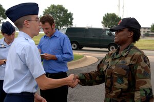 LANGLEY AIR FORCE BASE, Va. --  Senior Airman Yvonette France, 1st Civil Engineering Squadron, greets Cadet Chris Burtner, an Air Force Junior Reserve Officer Training Corps student from Menchville High School who shadowed her for the day here on July 24.  The cadets were participating in the Langley Air Force Base cadet officer leadership school, which Shadow Day is part of.  Shadow Day provides the cadets with an opportunity to meet active-duty Air Force members and gain insight into their career fields.  (U.S. Air Force photo/Tech. Sgt. Levi Collins)  