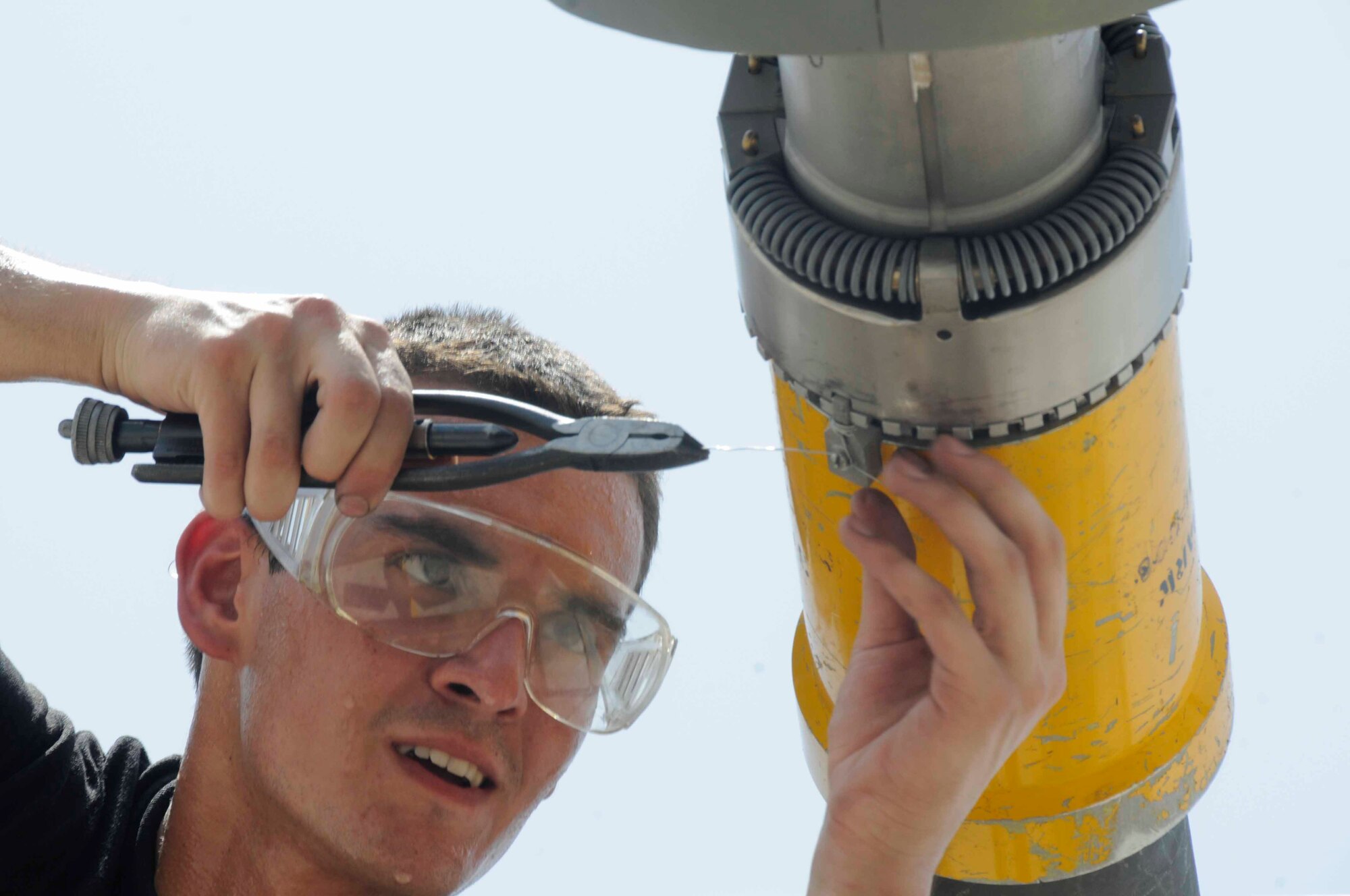 Airman 1st Class Jason Linehart, 379th Expeditionary Aircraft Maintenance Squadron, applies safety wiring to a drogue adapter of a KC-135 boom July 24 in Southwest Asia. The drogue adapter enables the KC-135 to refuel aircraft with different receiver systems. Airman Linehart is a crew chief deployed from McConnell Air Force Base, Kan. (U.S. Air Force photo/Staff Sgt. Darnell T. Cannady)