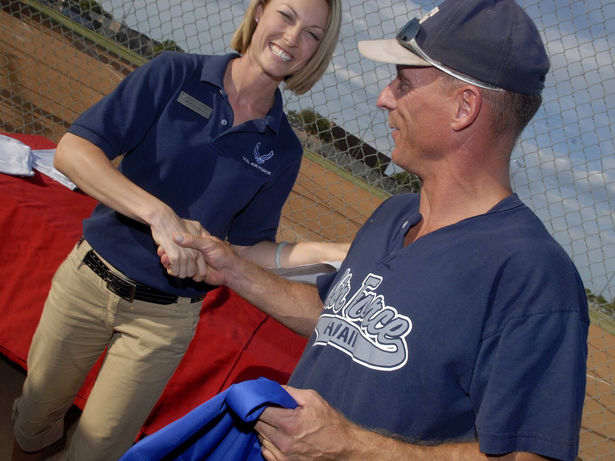 Charlie Rehburg, of the 17th Mission Support Group Junkyard Dogs, receives congratulations on being voted overall MVP for the 2008 Softball season by Goodfellow’s Sports Director Michelle Ammon. Rehburg was awarded a plaque and commemorative jersey for his outstanding athleticism. (U.S. Air Force photo by Senior Airman Kamaile Chan)