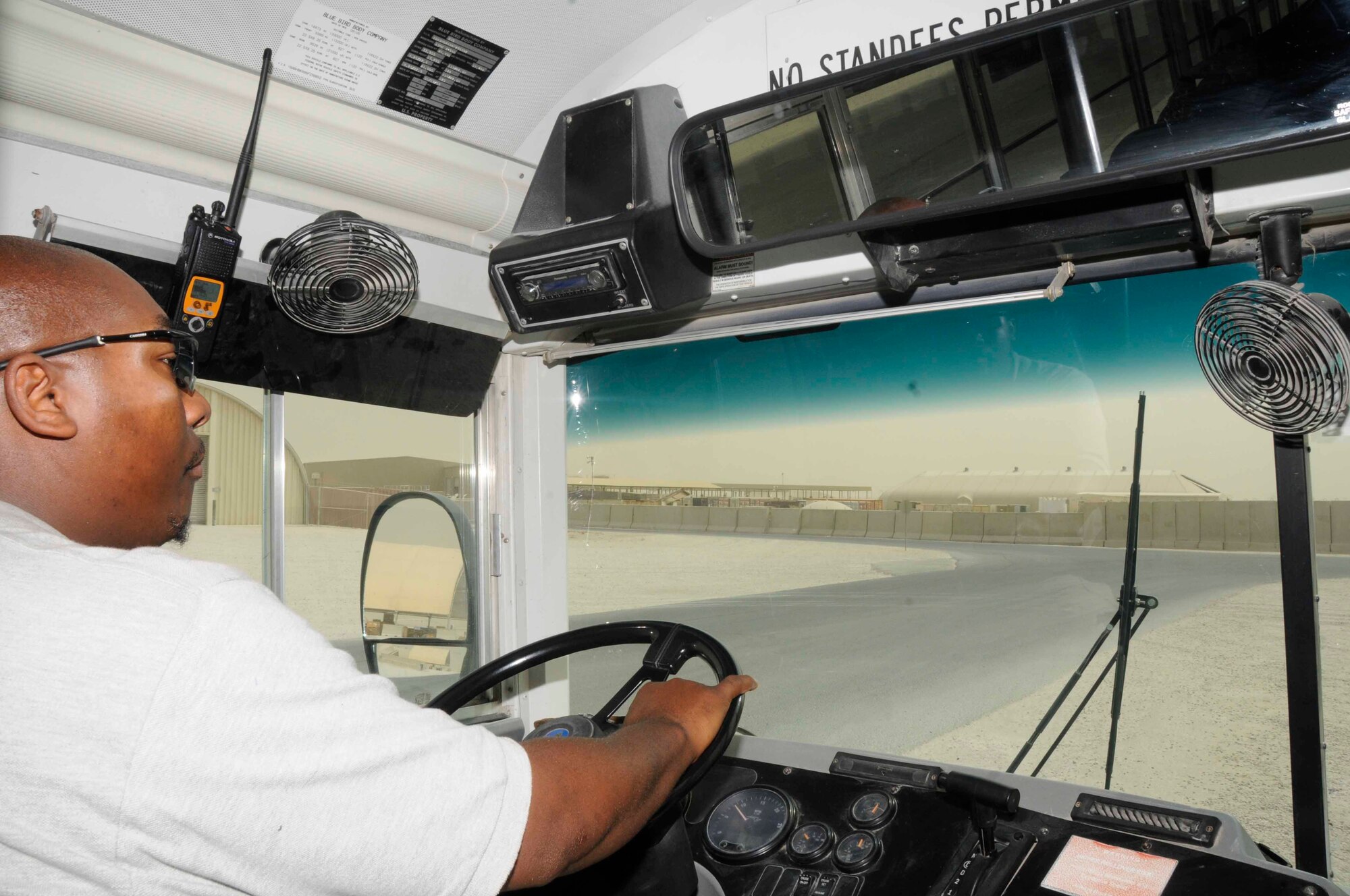 Terence Purifoye, 379th Expeditionary Logistics Readiness Squadron, picks up and drops off passengers at a bus stop in Southwest Asia July 22. Terence is a vehicle operator from Miami, Fla. (U.S. Air Force Photo/Staff Sgt. Darnell T. Cannady)