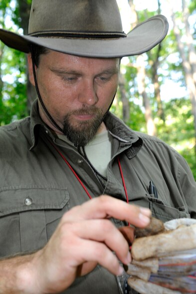 Base Archeologist Stephen Hammack examines a clod of dirt during the dig. U. S. Air Force photo by Sue Sapp