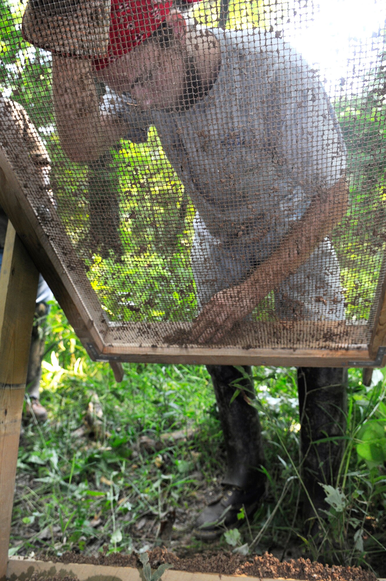 Joey Rantz, Mercer sophomore shakes dirt through a screen hoping to find an artifact.  U. S. Air Force photo by Sue Sapp