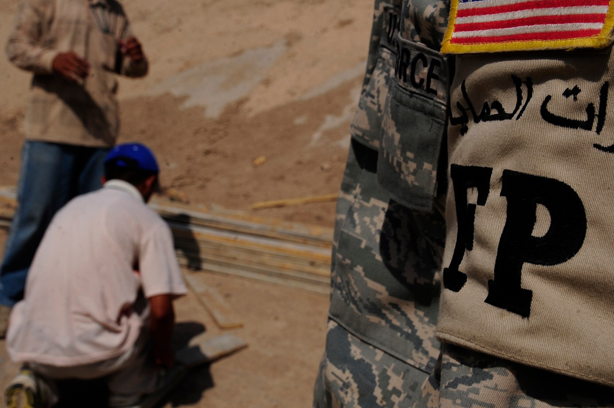 ALI BASE, Iraq -- Airman 1st Class Charles Boyd, 407th Expeditionary Security Forces Squadron, watches over third country nationals as they work here July 24, 2008. Airmen working in the 407th ESFS Force Protection Section are tasked with maintaining the installation's internal safety. Airman Boyd is deployed from the 65th Air Base Wing, Lajes Field, Azores, where he is a radar maintainer. (U.S. Air Force photo/Airman 1st Class Chris Griffin)