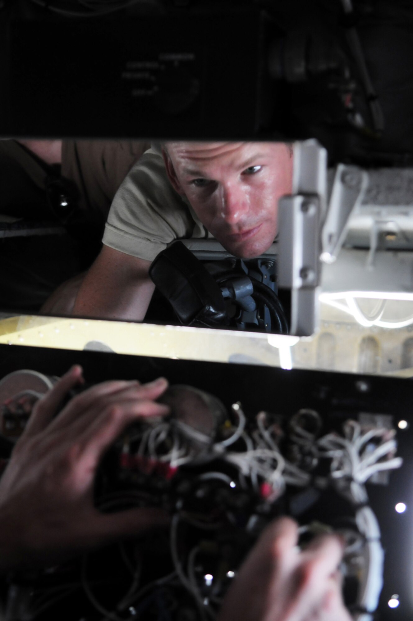 MANAS AIR BASE, KYRGYZ REPUBLIC -- Tech. Sgt. Jeremy Metzger, 376th Expeditionary Aircraft Maintenance Squadron, replaces a lighting transformer on a KC-135 here, July 23. The KC-135 Stratotanker provides the core aerial refueling capability for the United States Air Force and has excelled in this role for more than 50 years. (U.S. Air Force photo / Airman 1st Class Ruth Holcomb)
