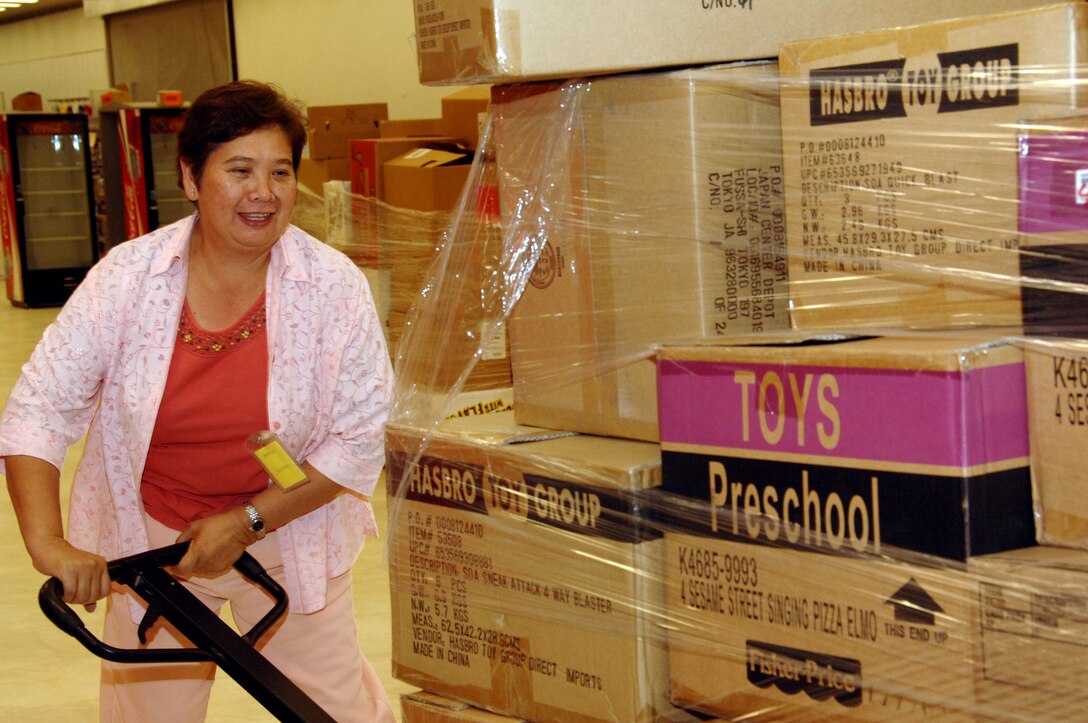 Belen Chambers an AAFES employee moves palettes of goods to the sales floor July 24 to fill the shelves in preparation of the grand opening celebration of the new Base Exchange on Sept. 10. The grand opening and ribbon cutting celebration of the BX promises to have great vendor giveaways, grand opening specials and a fill retail inventory valued at over 10 million dollars. (U.S. Air Force photo by Airman 1st Class Nichelle Griffiths)