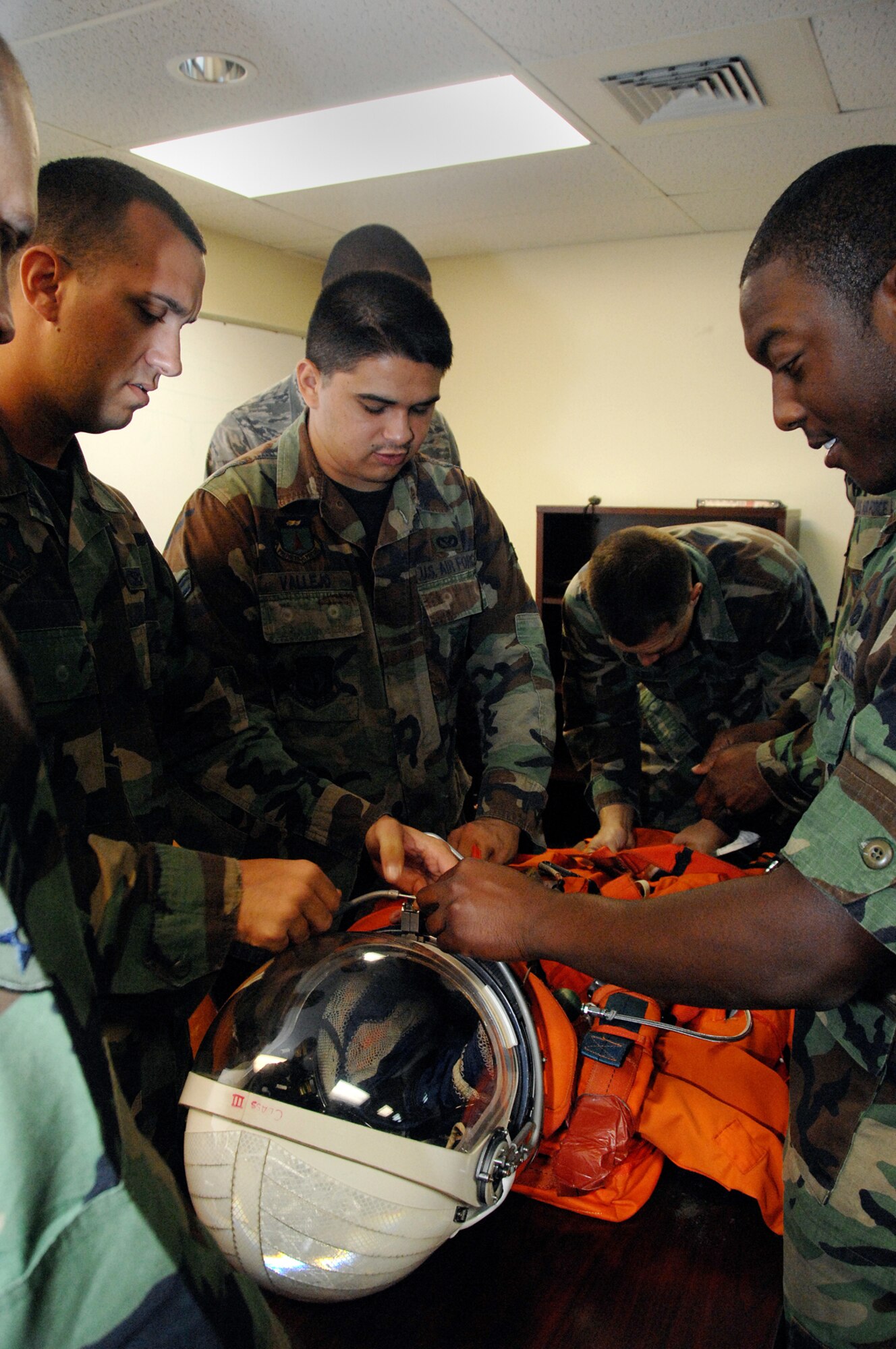 Andersen Air Force Base firemen familiarize themselves with one of NASA's space suits during Orbiter Response Procedures training July 23.  NASA trains the firefighters in emergency response procedures because Andersen is an alternate space shuttle landing site. (U.S. Air Force photo by Airman 1st Class Nichelle Griffiths)   
