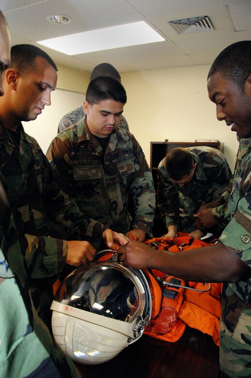 Andersen Air Force Base firemen familiarize themselves with one of NASA's space suits during Orbiter Response Procedures training July 23.  NASA trains the firefighters in emergency response procedures because Andersen is an alternate space shuttle landing site. (U.S. Air Force photo by Airman 1st Class Nichelle Griffiths)   
