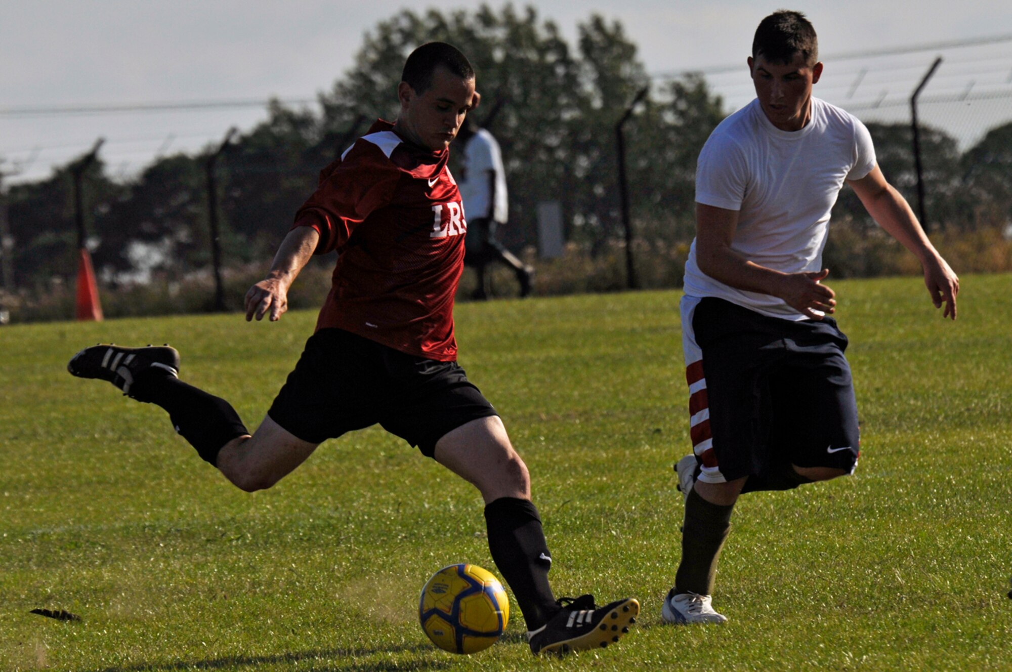 Robert Lubovich, 48th Logistics Readiness Squadron soccer team passes the ball away from Cody Colston, 48th Security Forces Squadron soccer team July 21 at RAF Lakenheath, England. LRS Airmen shut out the SFS 3 to 0 in the first playoff game. (U.S. Air Force photo by Airman Perry Aston) 