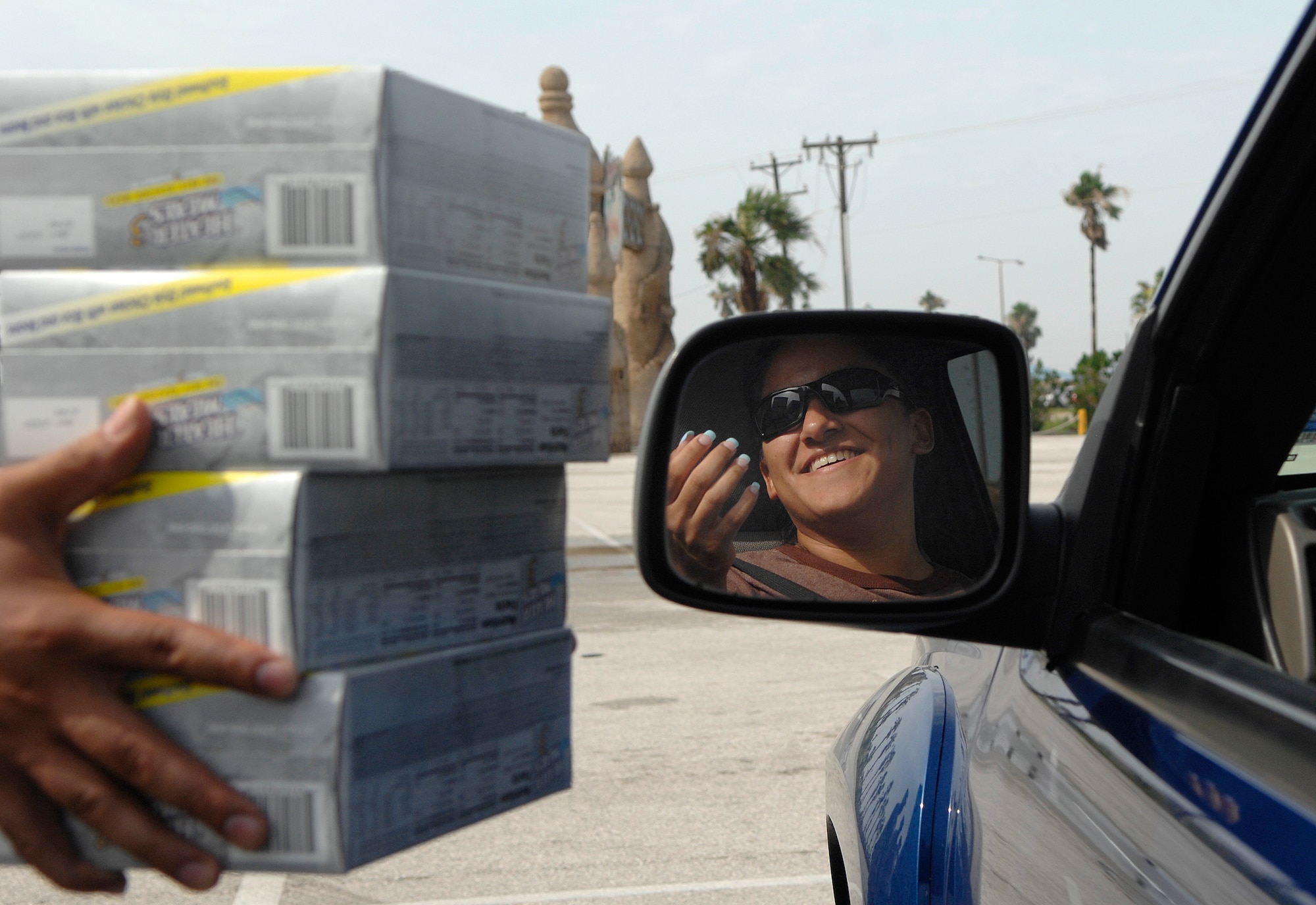 Relief task force members hand out self-heating food packages, bags of ice and cases of water July 24 to residents of South Padre Island, Texas, after the island was impacted by Hurricane Dolly. Task force members from the Army National Guard and civilian emergency response organizations were on hand to provide aid immediately following the hurricane. (U.S. Air Force photo/Staff Sgt. Bennie J. Davis III)