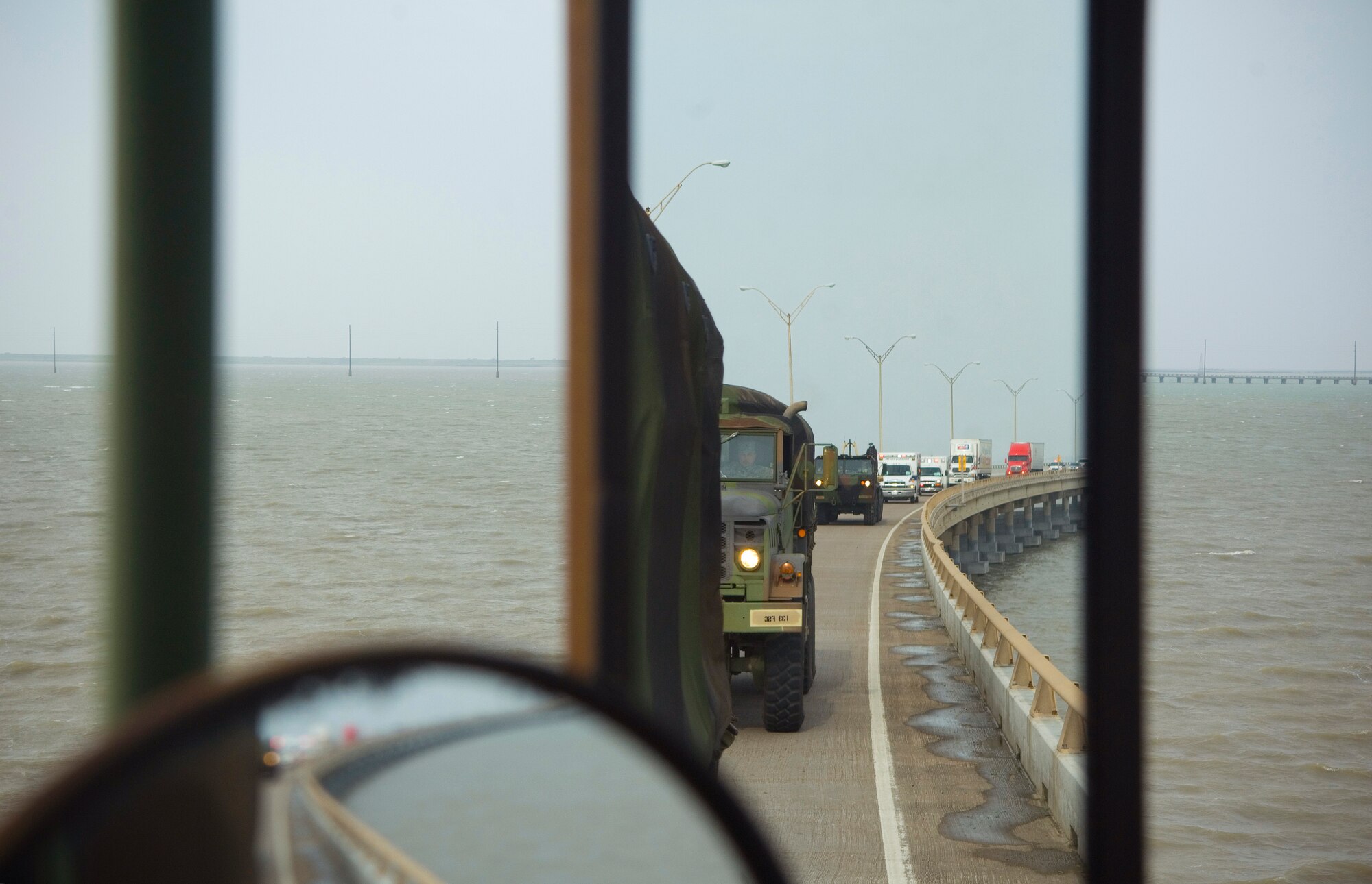 A Texas task force convoy crosses a two-mile bridge July 24 bringing food, water and ice to the people of South Padre Island, Texas. Hurricane Dolly made landfall at the island. (U.S. Air Force photo/Staff Sgt. Bennie J. Davis III)