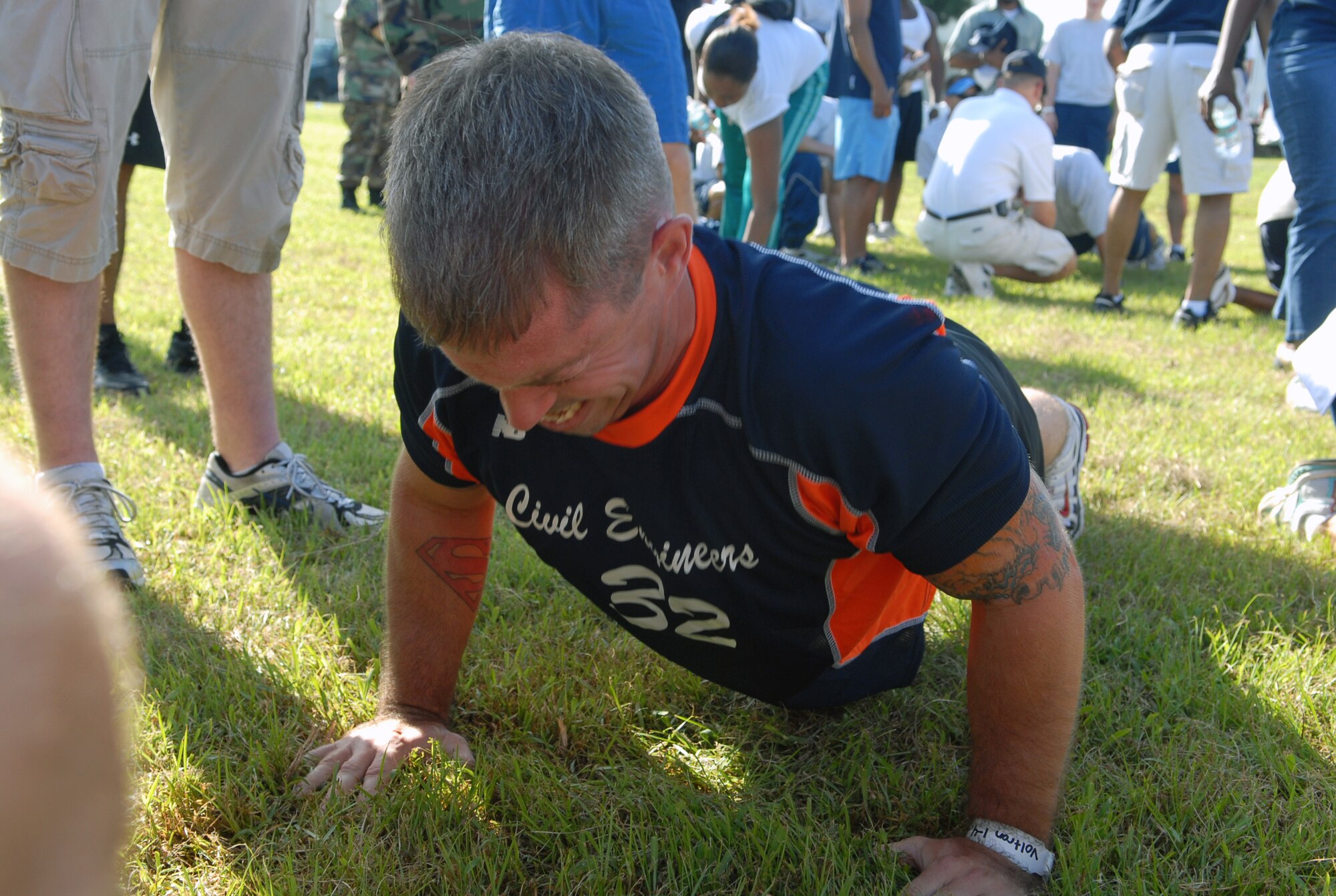 Staff Sgt. Anthony Branscum, 18th Civil Engineer utilities journeyman knocks out pushups for the 18th CES team during the Joint Services Fitness Challenge July 18. The fitness challenge gathered together 26 teams from various military branches and units to compete against one another in multiple exercise challenges.  Kadena’s own 31st Rescue Squadron walked away with the first and second place trophies and the opportunity to defend their title next year. (U.S. Air Force photo/Staff Sgt. Christopher Marasky) 