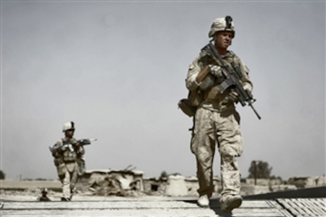 U.S. Marines serving with 1st Platoon, Bravo Company, Battalion Landing Team, 1st Battalion, 6th Marine Regiment, 24th Marine Expeditionary Unit, NATO, International Security Assistance Force cross an expansion bridge while on patrol in the Helmand province of Afghanistan on July 1, 2008.  