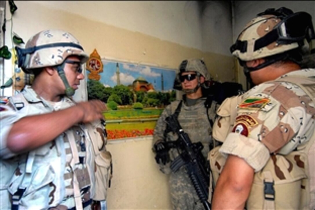 U.S. Army Sgt. Robert Tepera, center, speaks with Iraqi army soldiers about patrols being conducted in Saydiyeh, Baghdad, Iraq, July 22, 2008. Tepera is assigned to the 3rd Infantry Division's Company A, 4th Battalion, 64th Armor Regiment.
