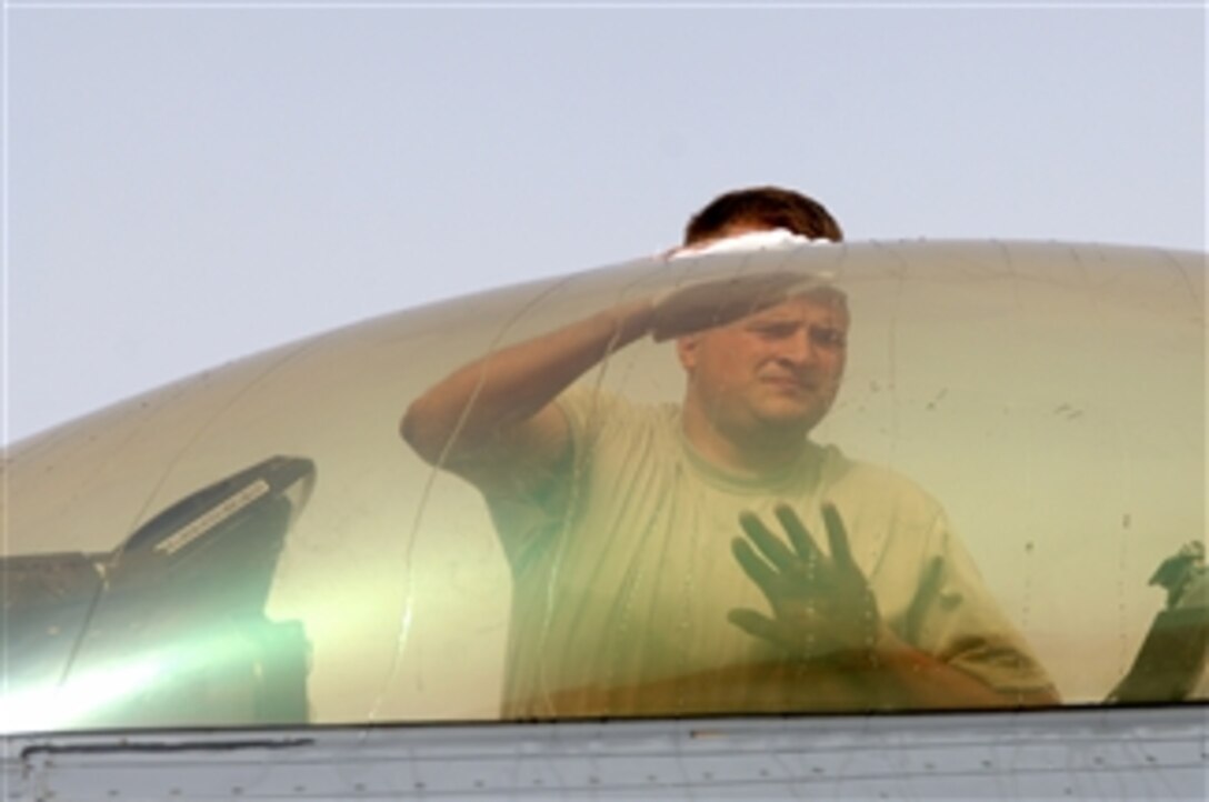 U.S. Air Force Senior Airman Zac Sedlmayr, a 332nd Expeditionary Aircraft Maintenance Squadron crew chief, wipes down the canopy of an F-16 Fighting Falcon aircraft at Balad Air Base, Iraq, on June 3, 2008.  