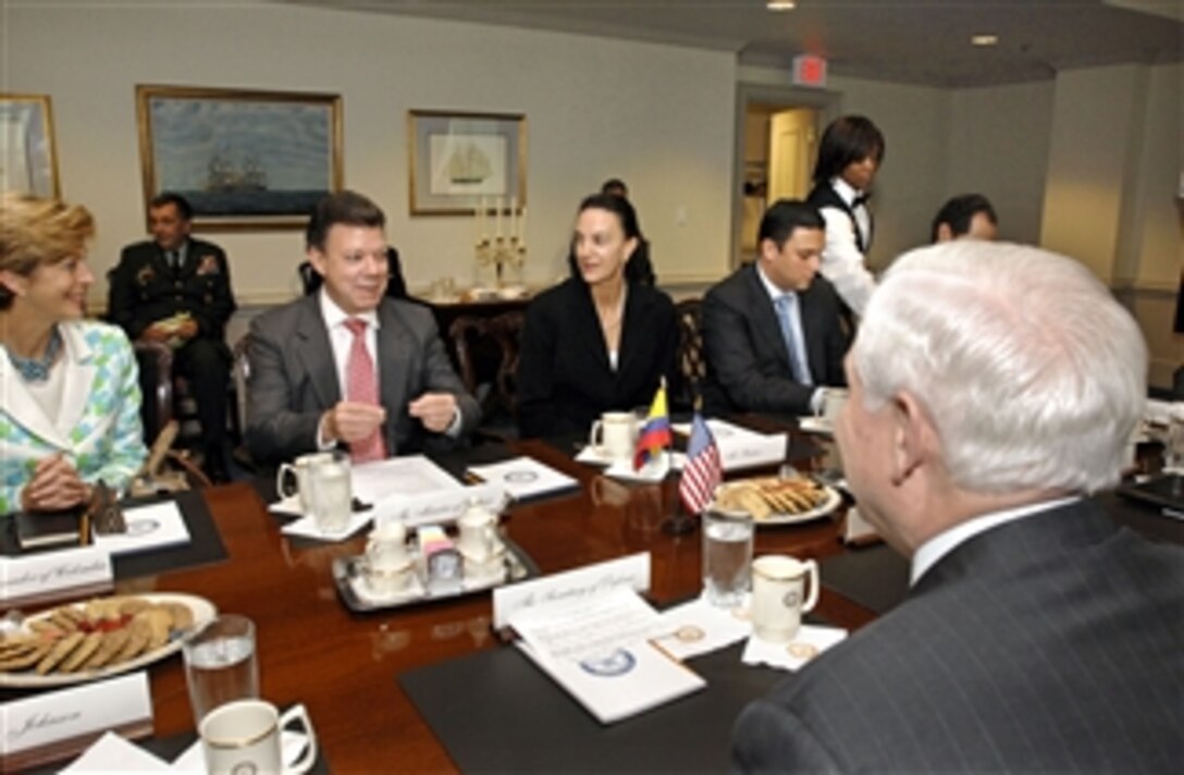 Colombian Minister of Defense Juan Manuel Santos (2nd from left) explains to Secretary of Defense Robert M. Gates some of the details of the recent hostage rescue mission his forces conducted against the Revolutionary Armed Forces of Colombia, known as FARC, in the Pentagon on July 23, 2008.  Santos is in the Pentagon for security discussions with Gates and his senior advisors.  Joining Santos are (left to right):  Colombia's Ambassador to the U.S. Carolina Barco, Deputy Chief of Mission Mariana Pacheco, Chief of Staff Juan Carlos Mira and Special Advisor to the Minister of Defense Alejandro Gamboa.  