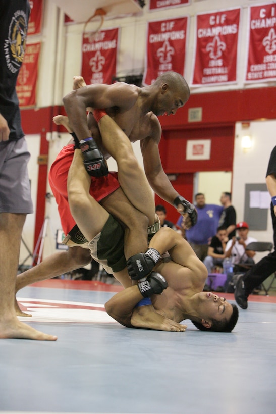 Dominique Waters, Fight Club 29 fighter, prepares to swing at an opposing teammate clinging to his leg during the USA National Pankration Team Championships tournament held at Santa Ana High School in Orange County, Calif., Saturday, July 26, 2008. Waters, one of the newest fighters to join Fight Club 29, is a 19-year old freestyle wrestler by trade.