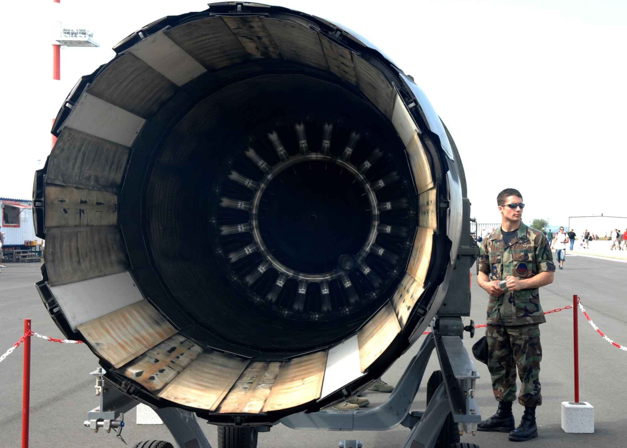 SPANGDAHLEM AIR BASE, Germany – Airman Christian Davey, 52nd Component Maintenance Squadron, stands ready to explain the General Electric 129 F-16 jet engine to interested visitors during the Open House, July 26, 2008. (U.S. Air Force photo by Airman Staci Miller)