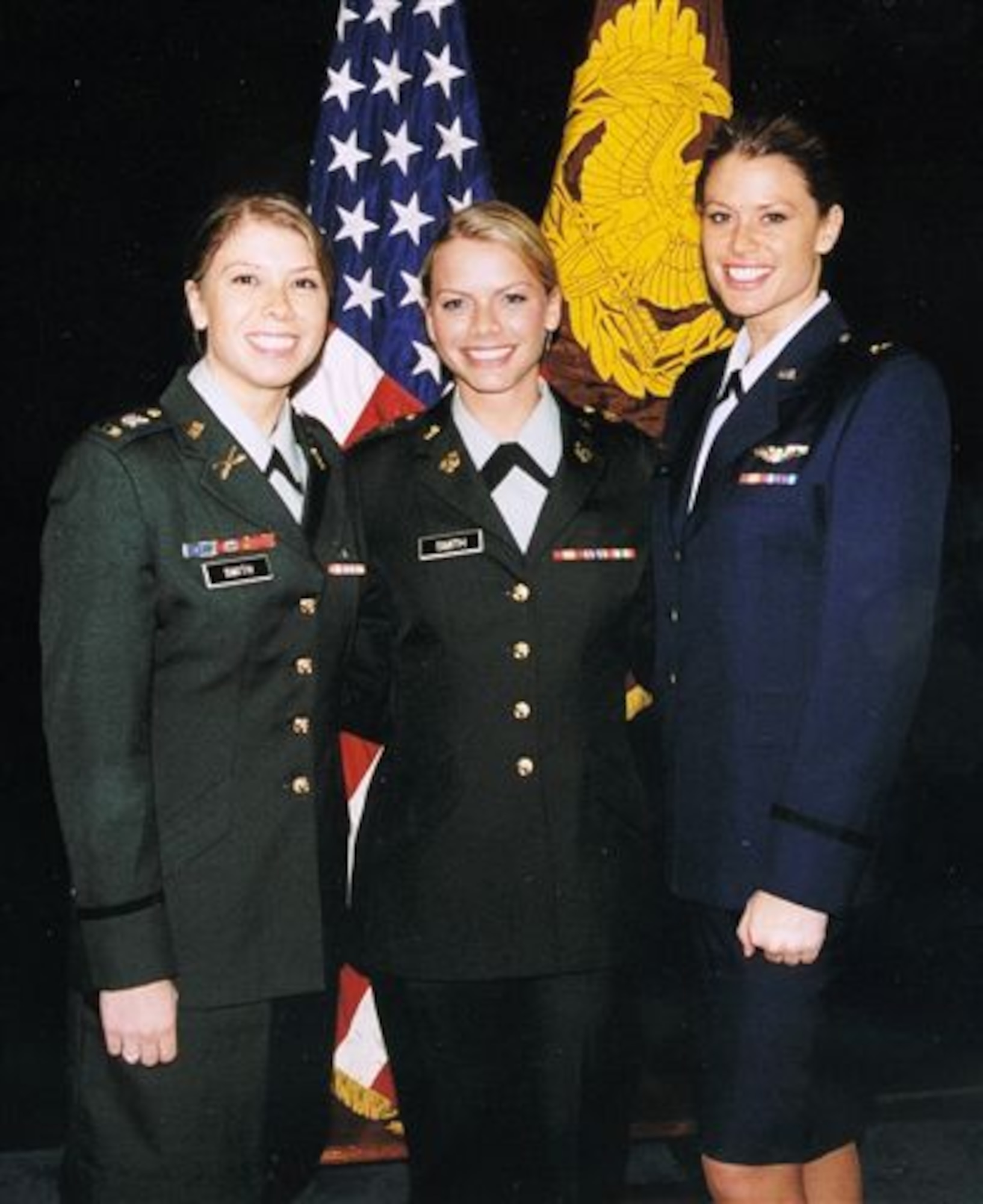 Army Chief Warrant Officer Amber Smith (left) and Air Force Capt. Kelly Smith (right) celebrate at a graduation for their younger sister, Army Chief Warrant Officer Lacey Smith (center). All three Smith sisters are pilots in the armed forces. (Courtesy photo)