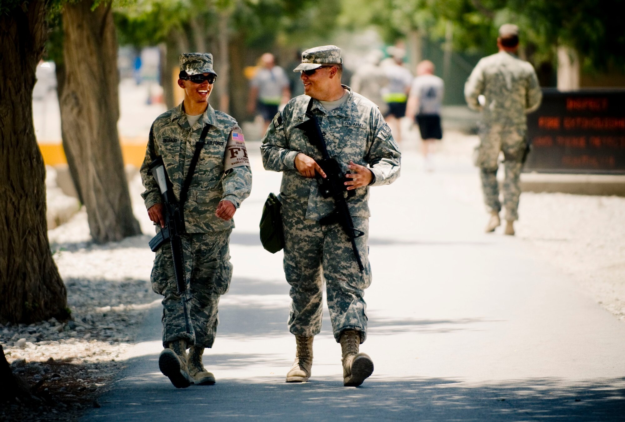 BAGRAM AIR FIELD, Afghanistan -- Senior Airman Matt Delgado (left) and his brother Army Private 1st Class Jerin Delgado (right) walk down Disney Drive here on July 17, 2008. The two had the opportunity to have face to face conversation despite being thousands of miles from home, a rarity when deployed. The brothers are both stationed in and call Texas their home. (U.S. Air Force photo by Staff Sgt. Samuel Morse)