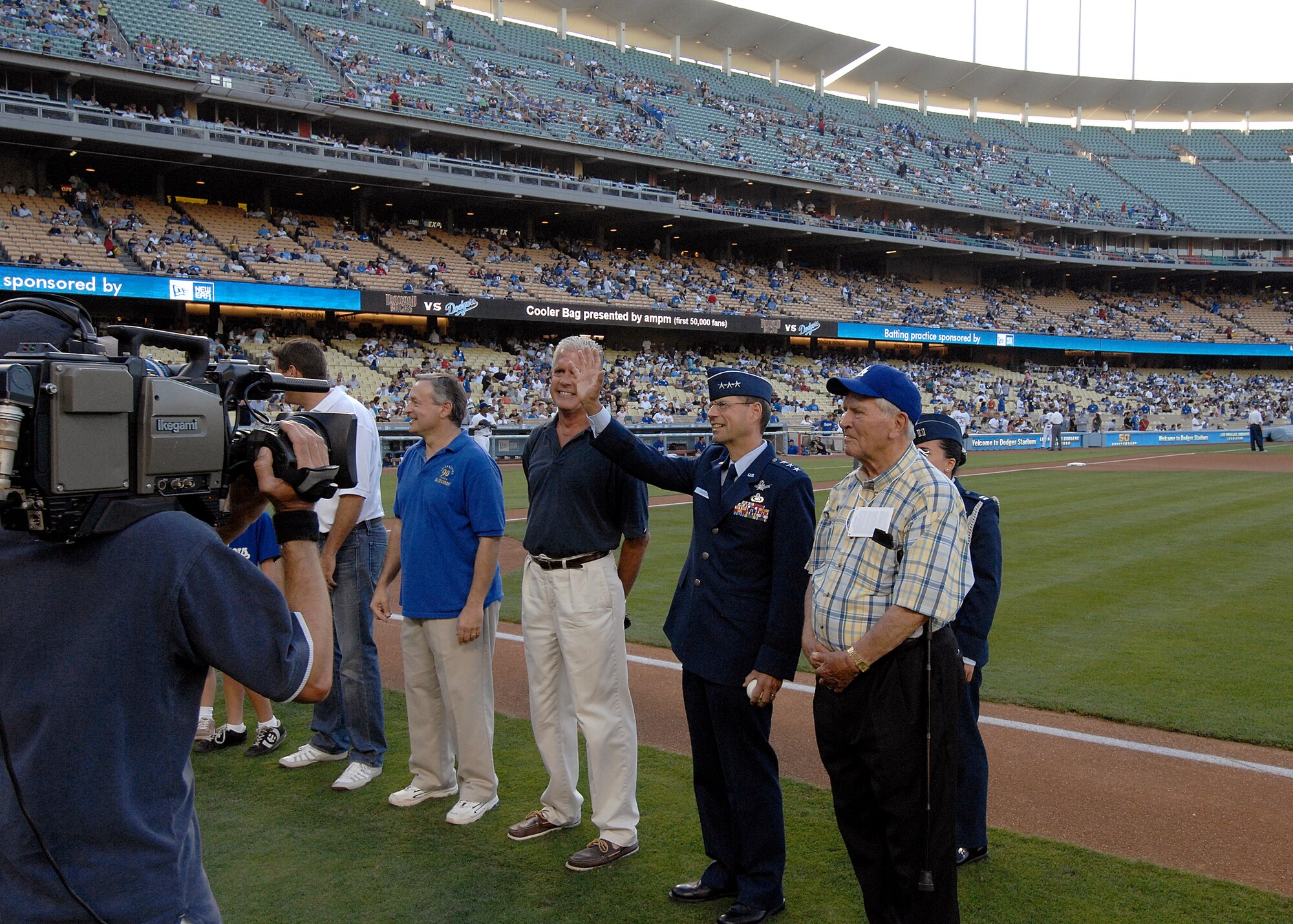Lt. Gen. Tom Scheridan (second from right, front row), Space and Missile Systems Center commander, waves to the crowd after being introduced at the start of the Dodger game celebrating the city of El Segundo, July 26. (Photo by Stephen Schester)